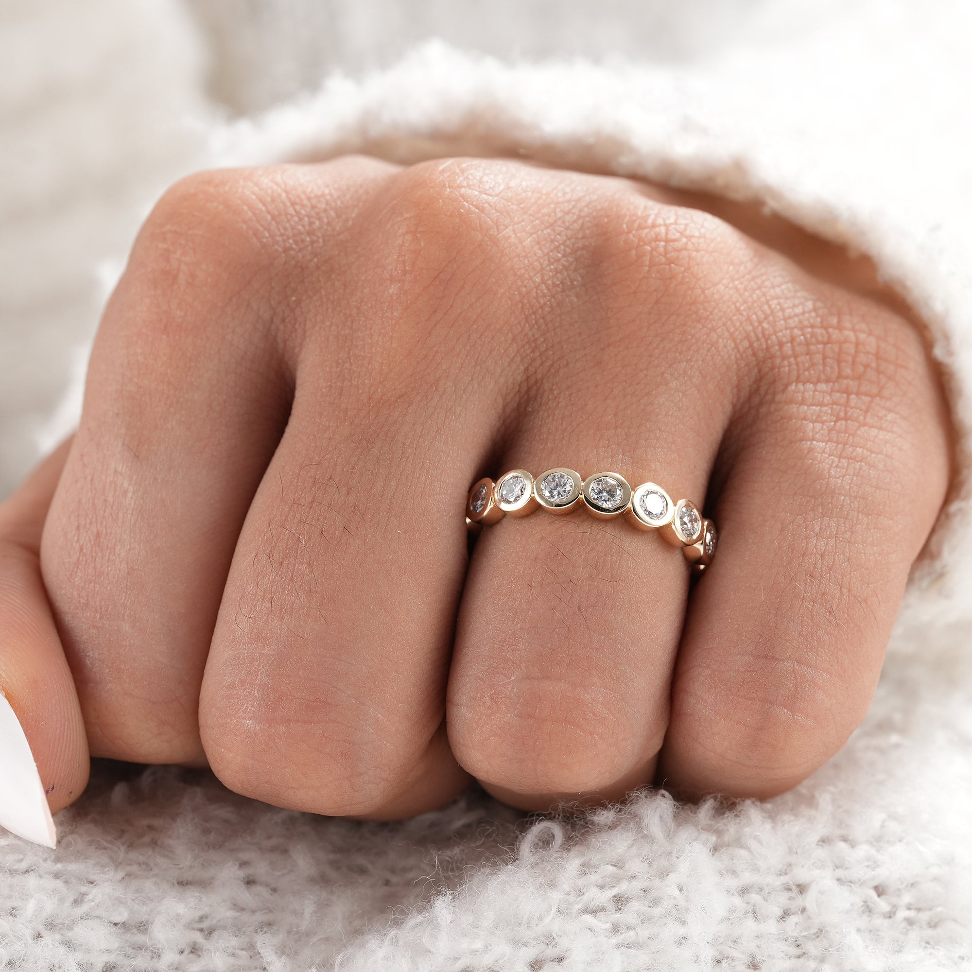 Elegant round diamond bezel set wedding ring.