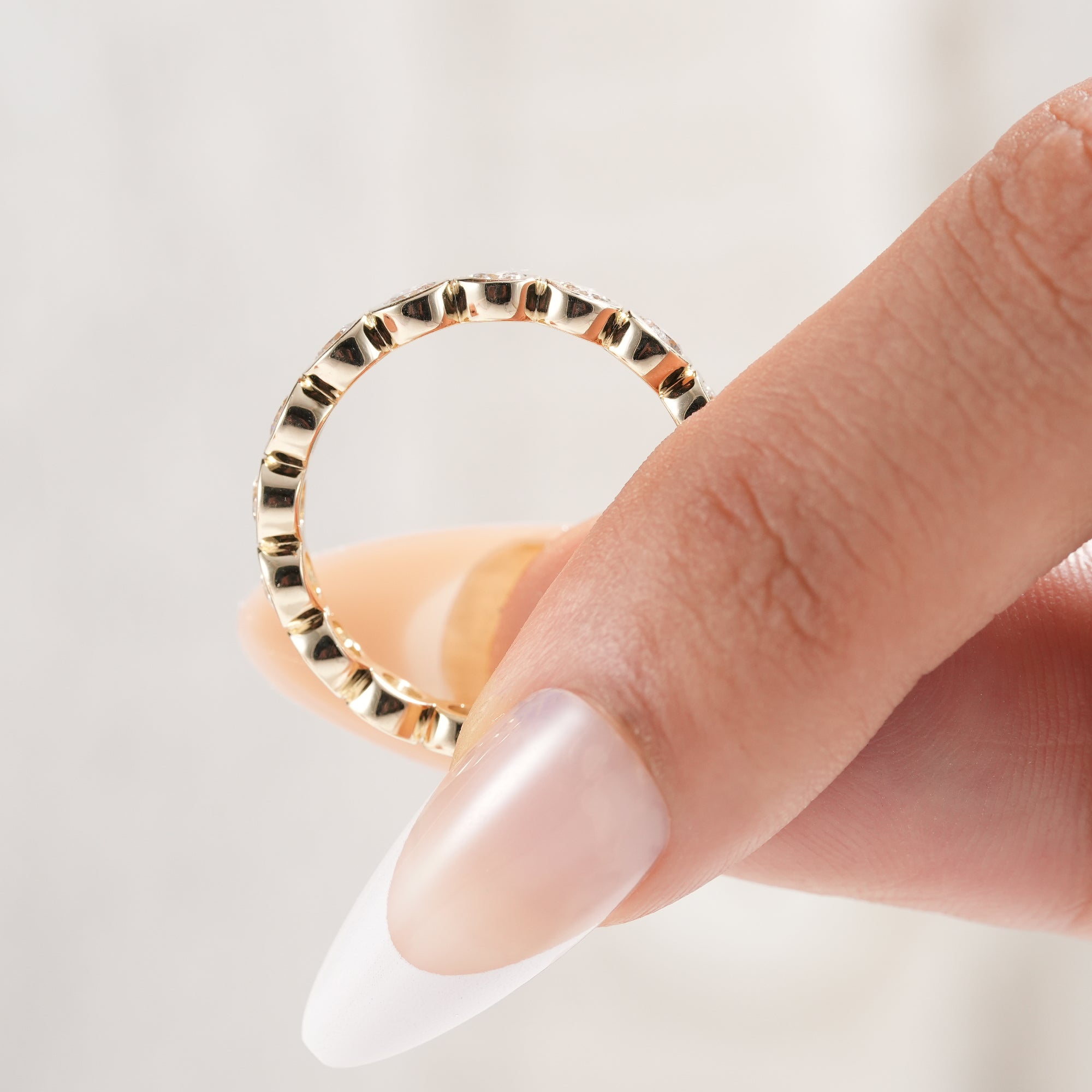 Round brilliant diamond bezel wedding band with full eternity design.