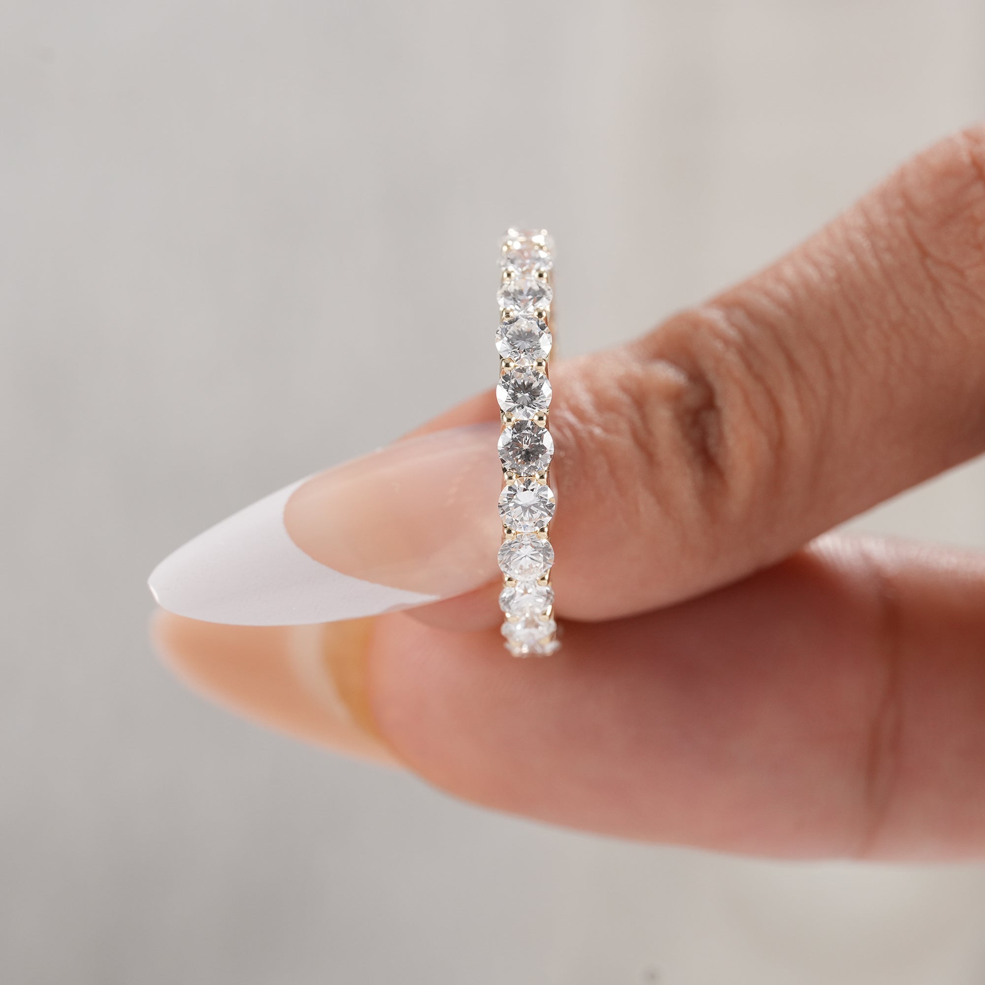 Fine jewelry eternity band with continuous round diamonds.