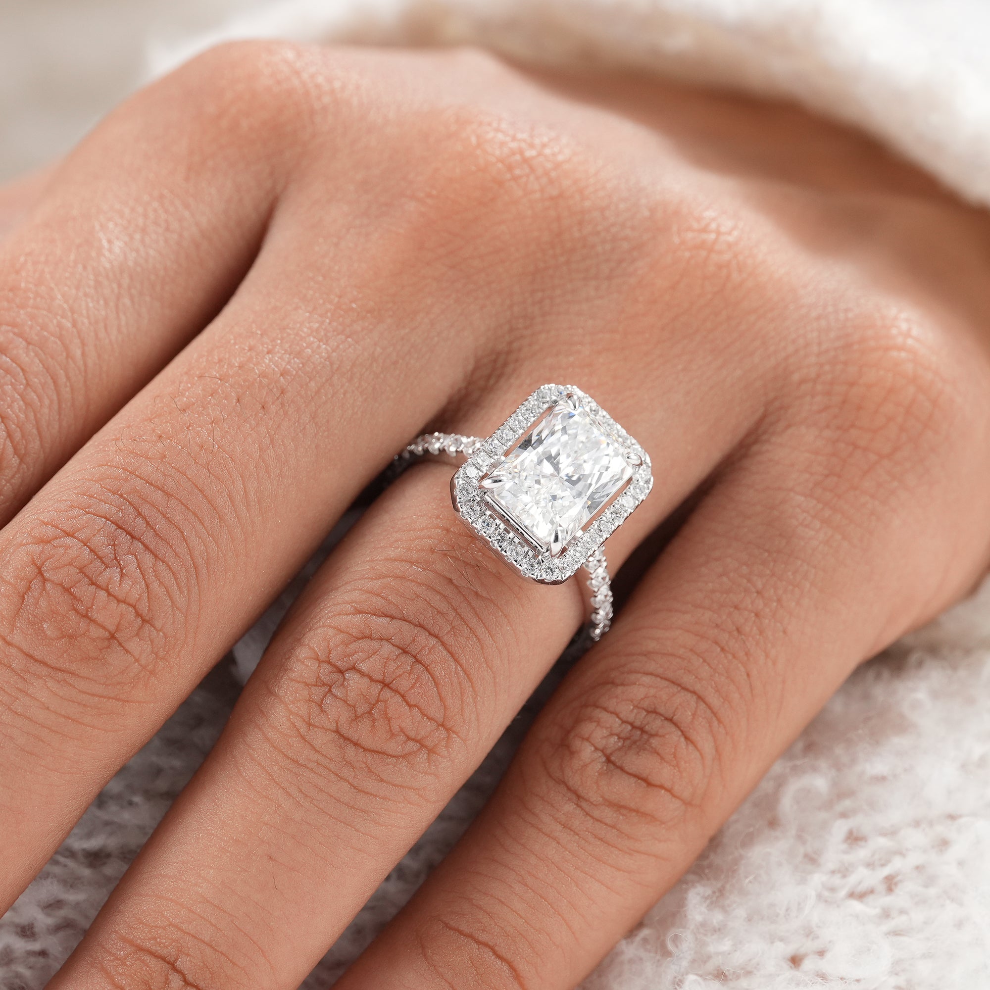 Ethical IGI certified radiant diamond halo ring.