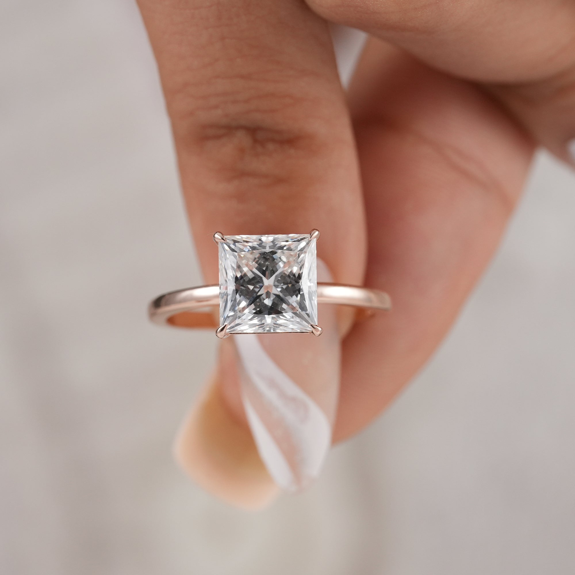 Luxury lab grown princess diamond ring close-up.