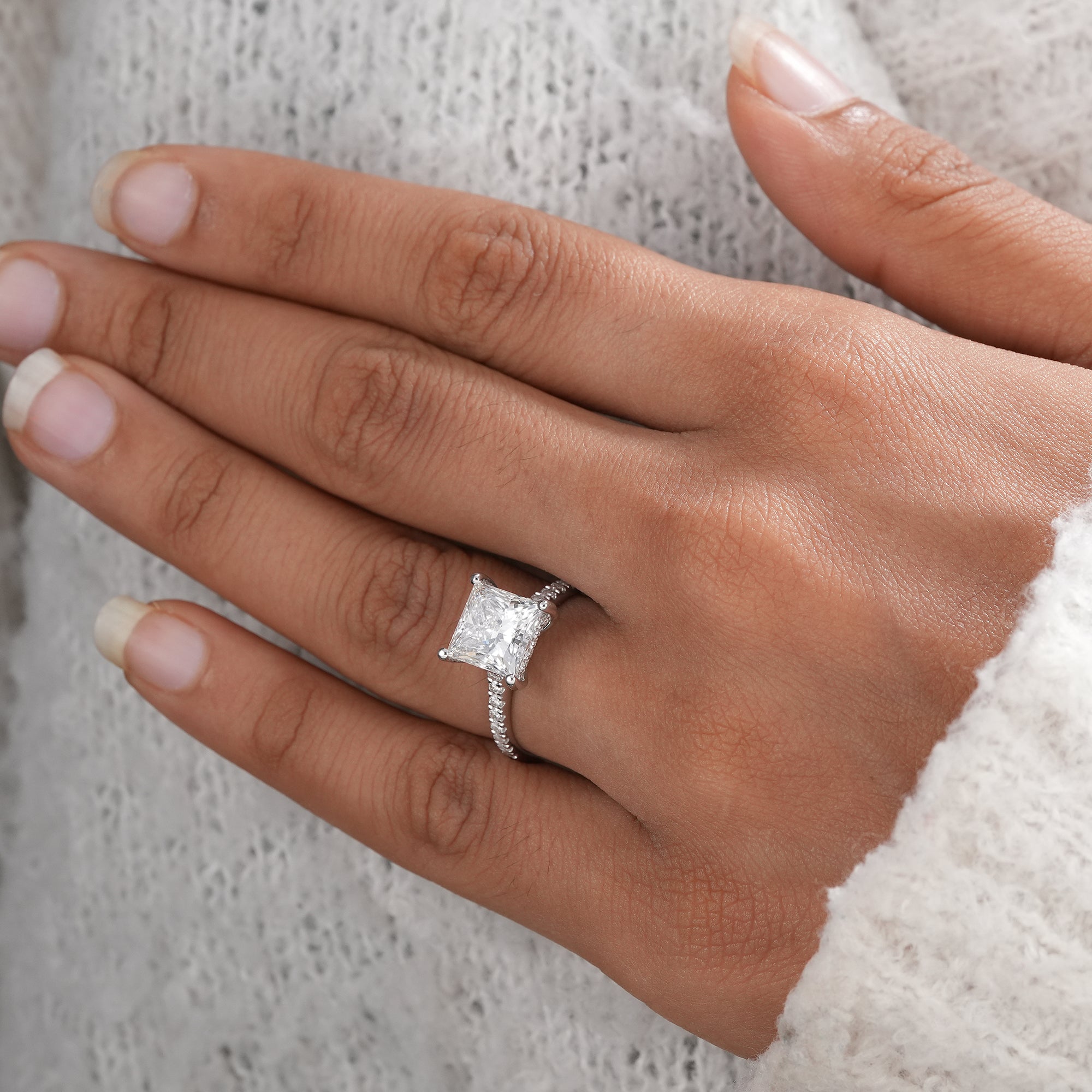 Luxury princess cut solitaire ring with hidden halo diamonds.