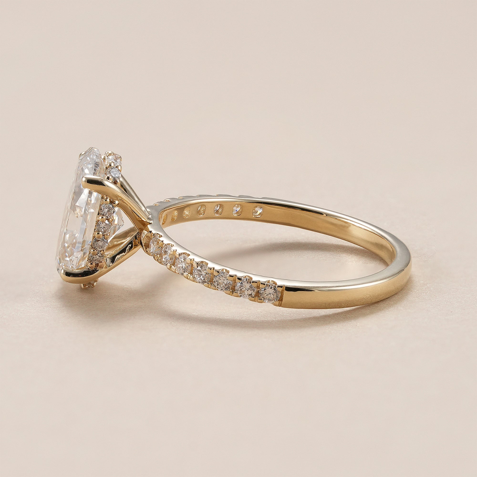 Oval solitaire lab grown diamond ring with pavé diamond band.