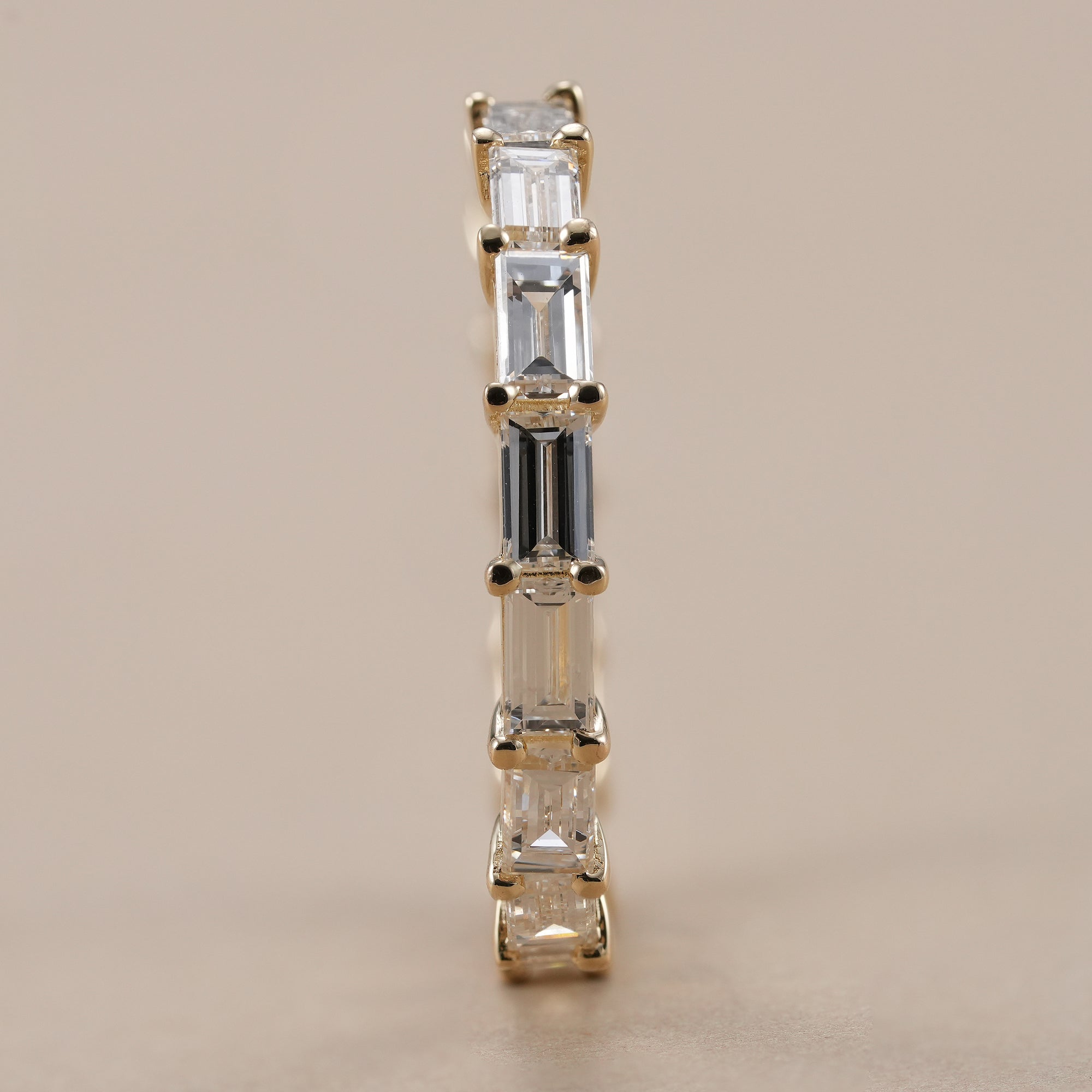 Baguette cut diamond wedding band with shared prong setting.