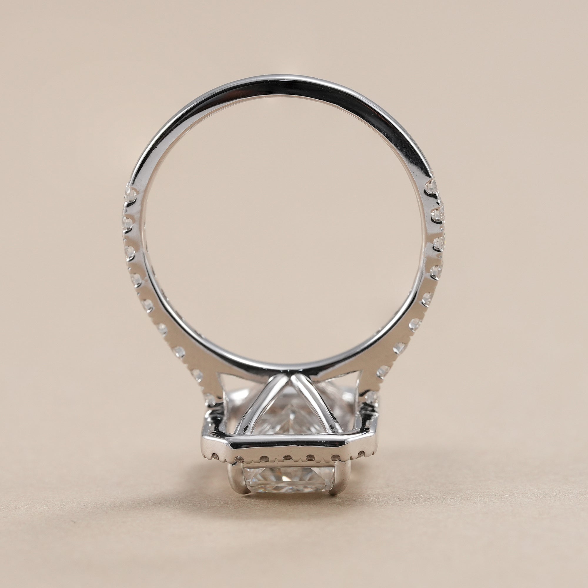 Halo engagement ring featuring a radiant cut center diamond.