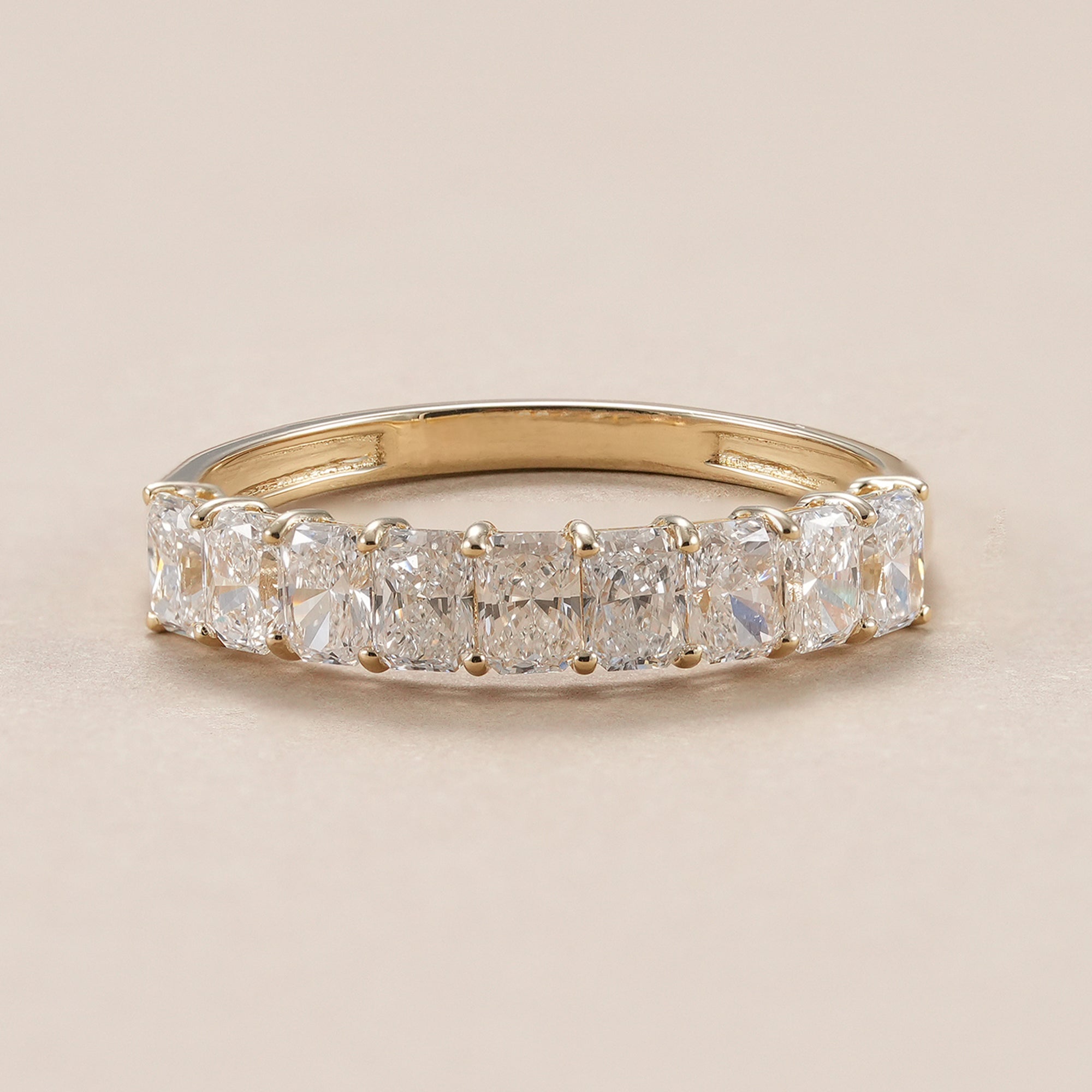 Radiant lab grown diamond wedding band in yellow gold.