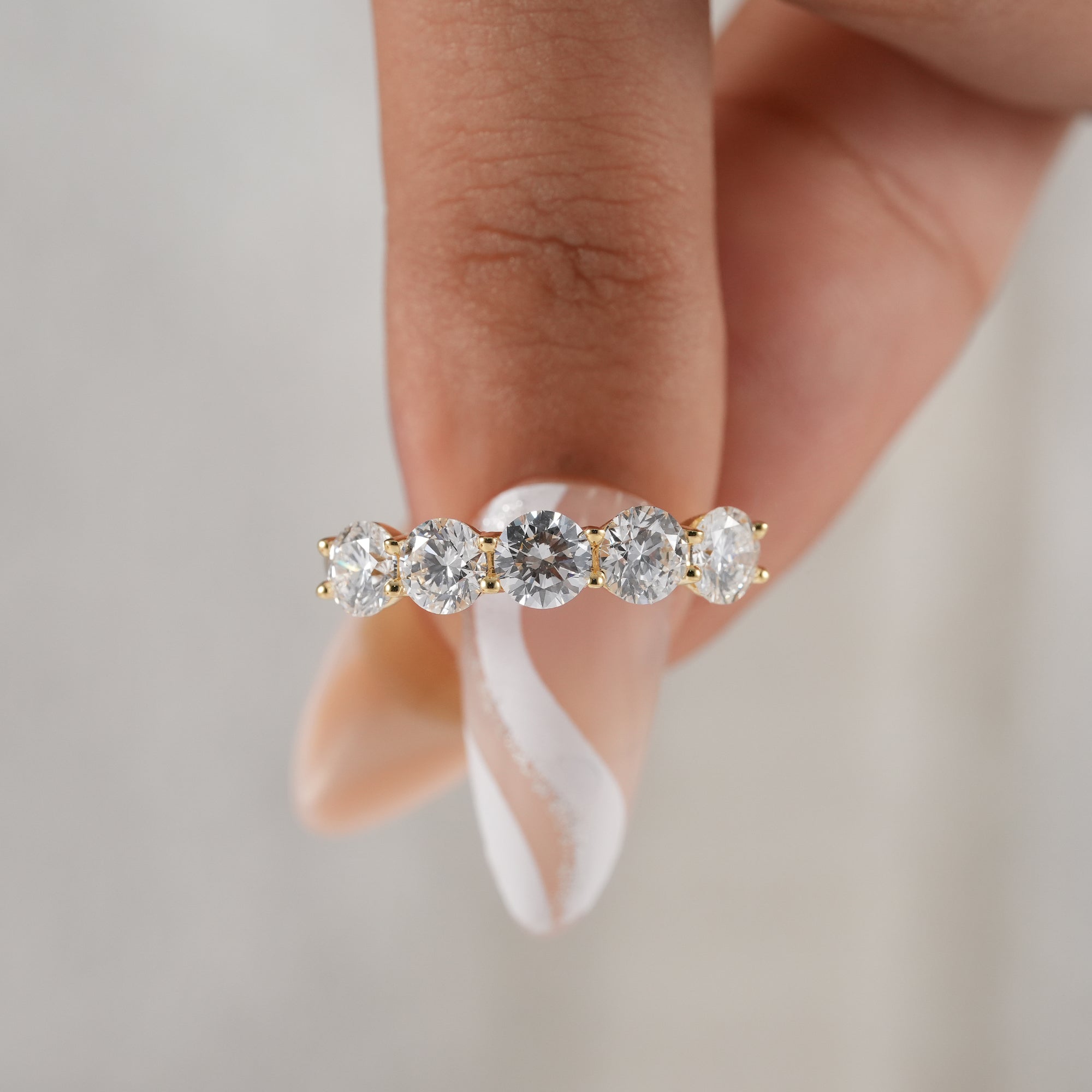 Handmade round diamond wedding ring in polished yellow gold.