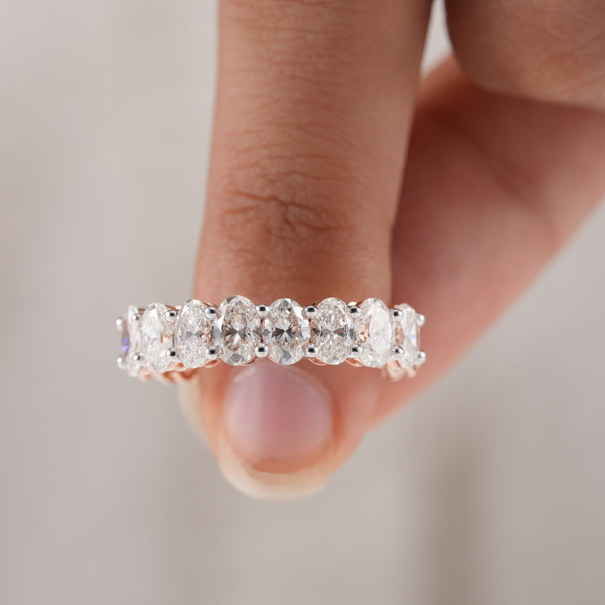 Rose gold oval diamond eternity band for bridal jewelry.