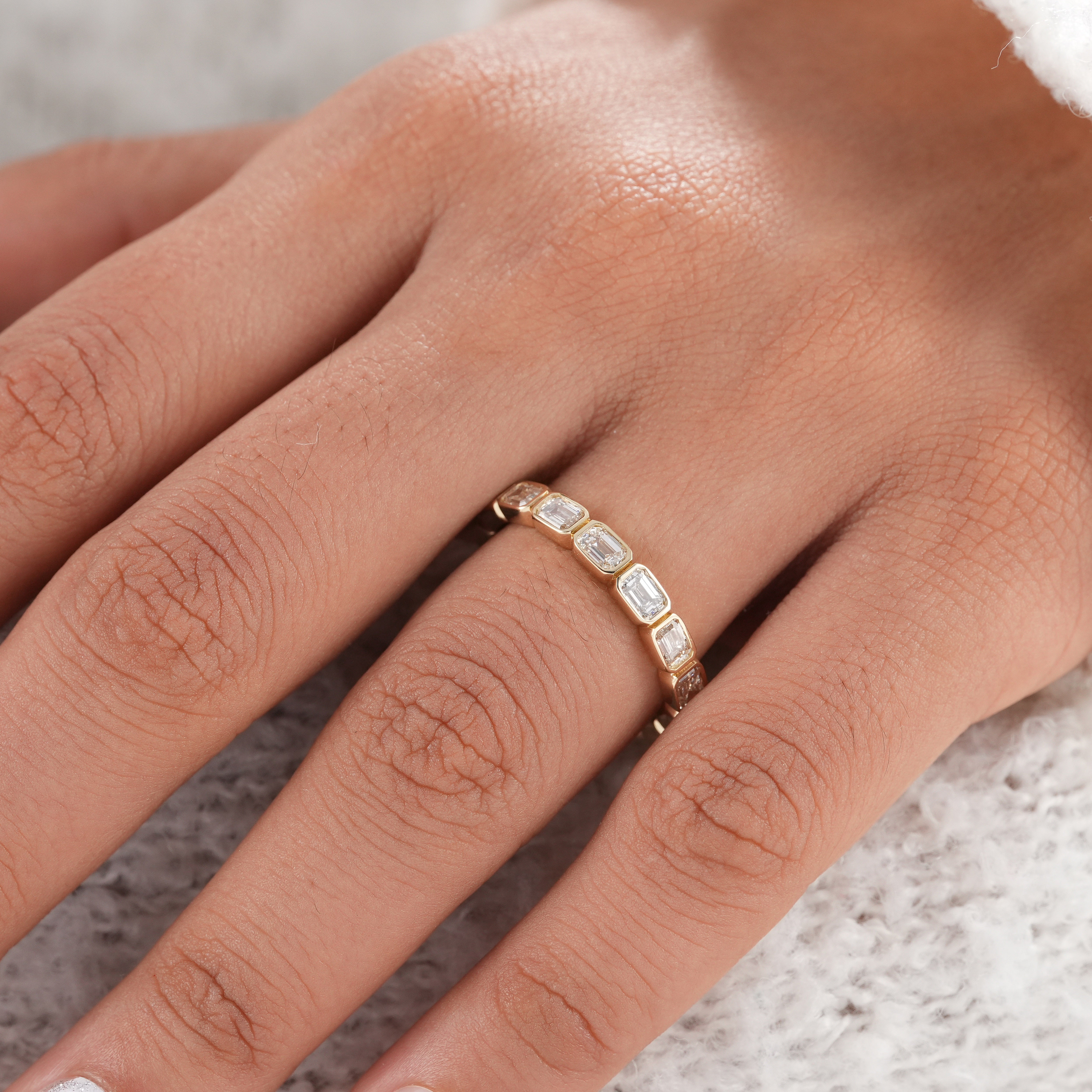 Fine jewelry emerald cut diamond eternity ring.
