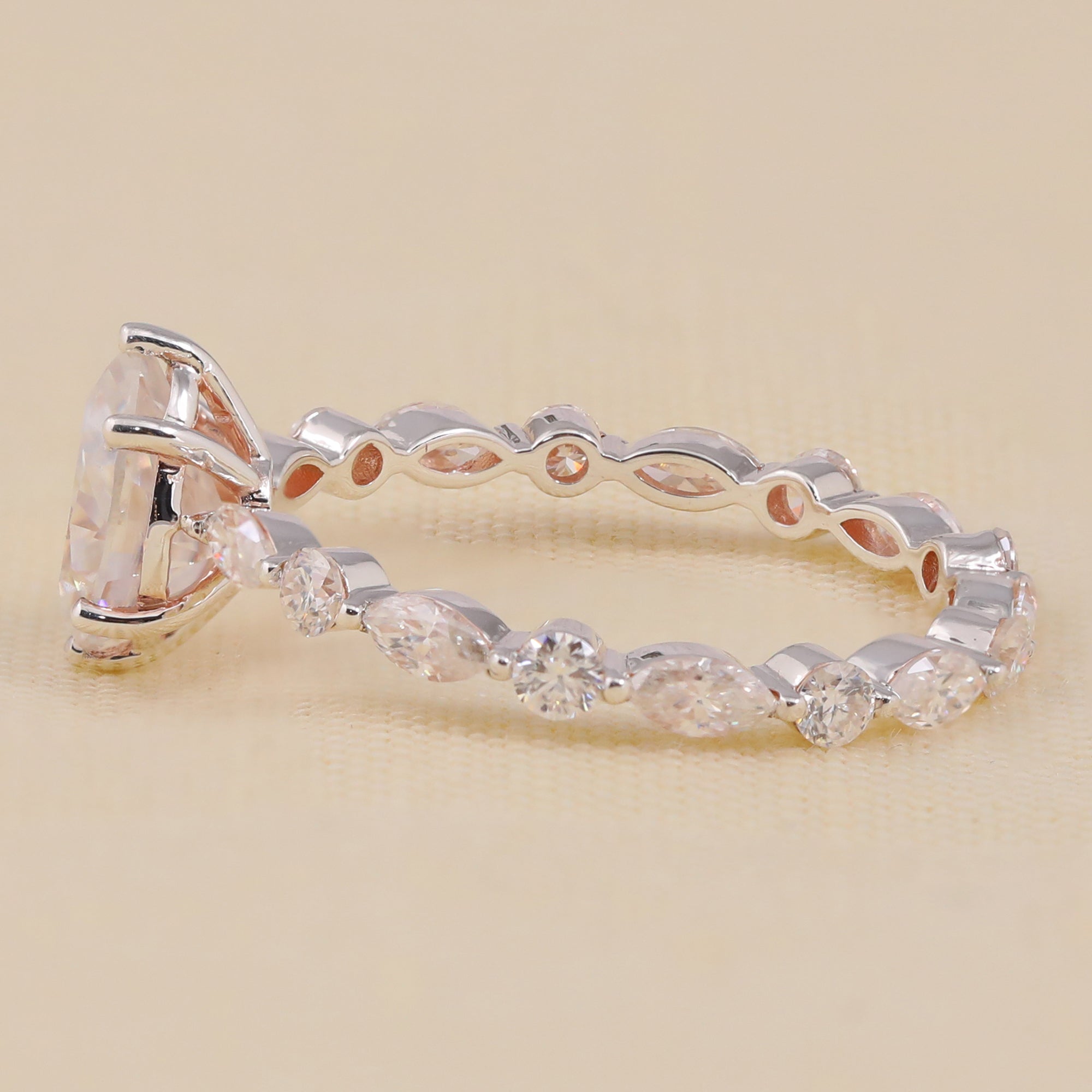 Pear shaped lab created diamond ring with unique marquise accent band