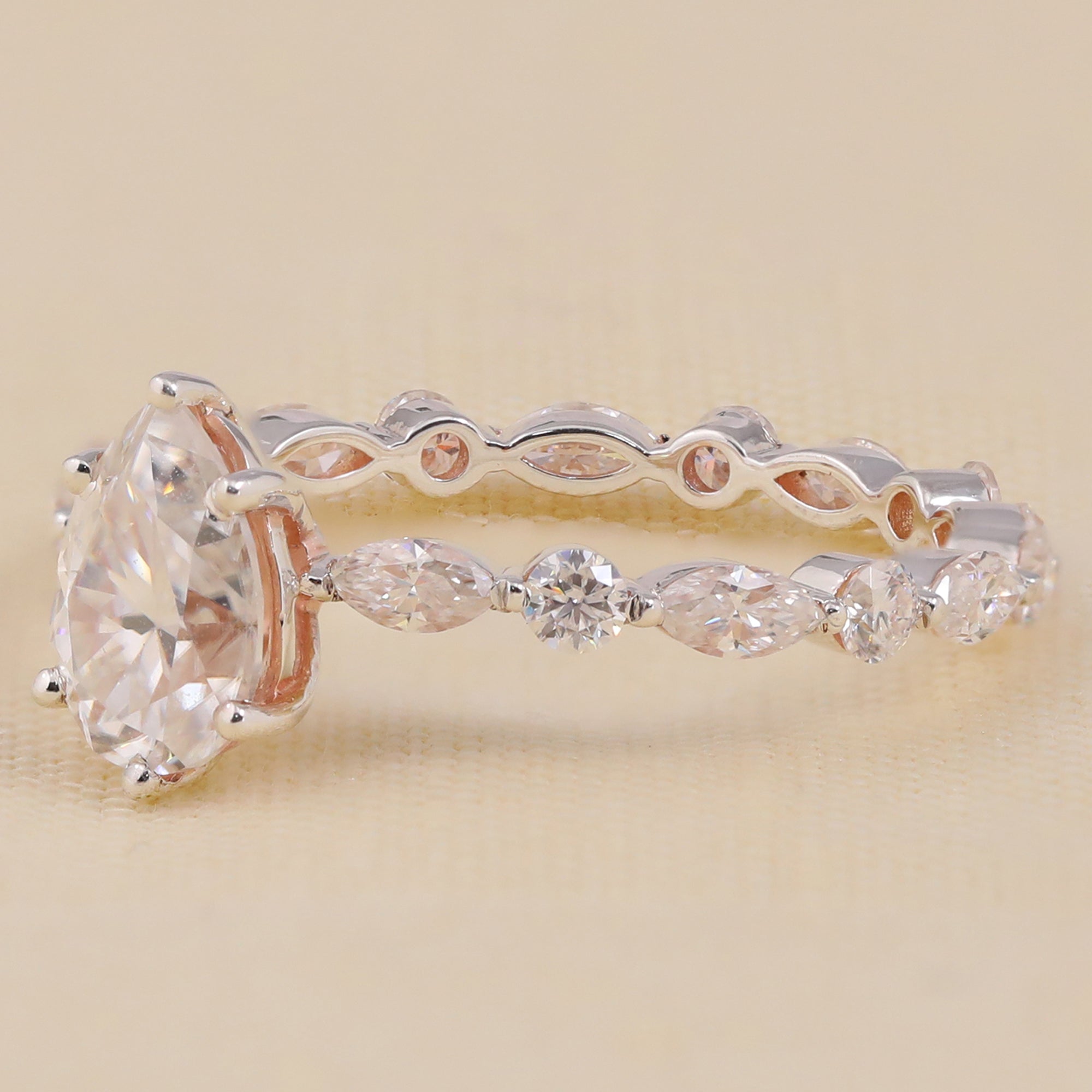 Teardrop lab grown diamond bridal ring with vintage side stone design