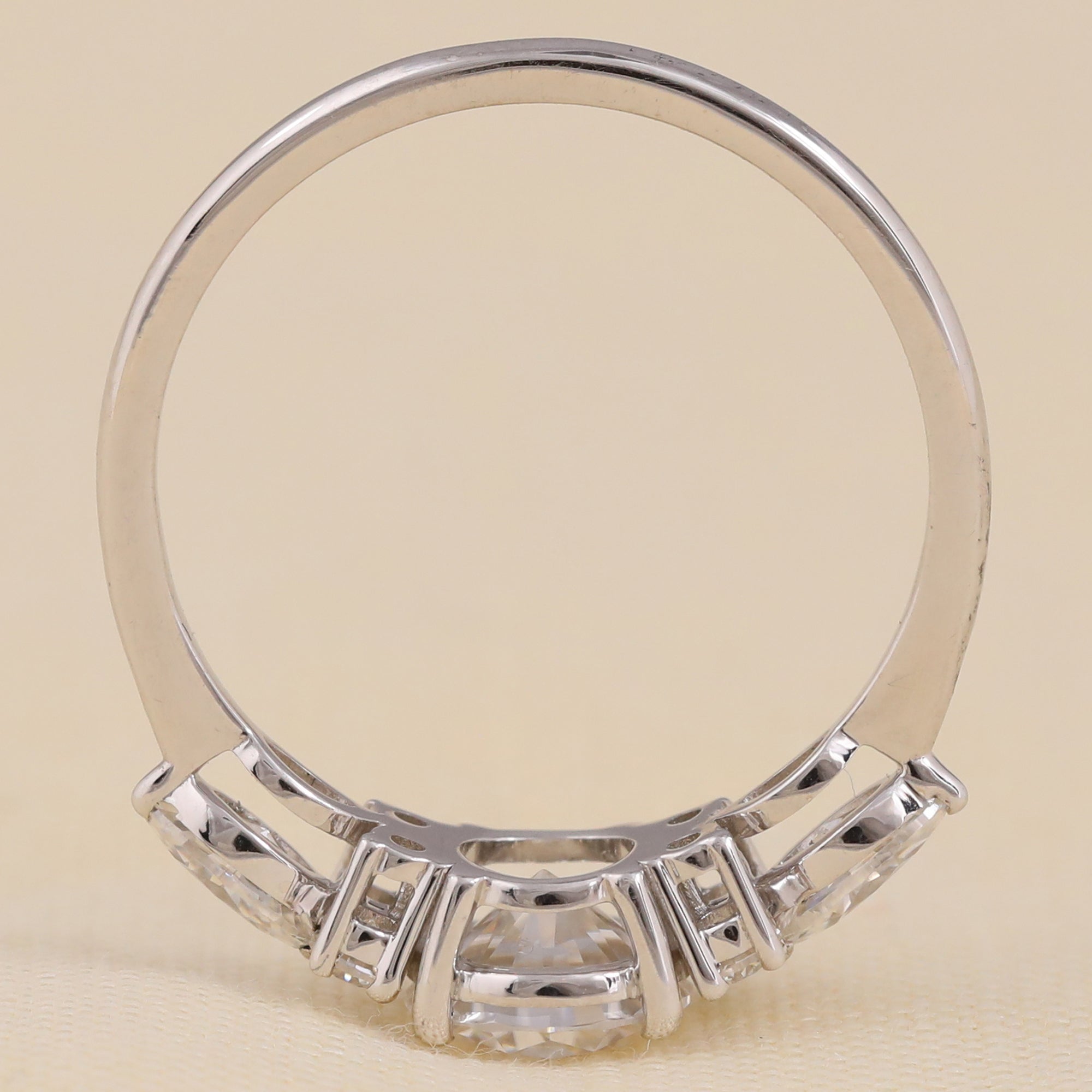 Sustainable lab created diamond ring with round solitaire and marquise side diamonds.