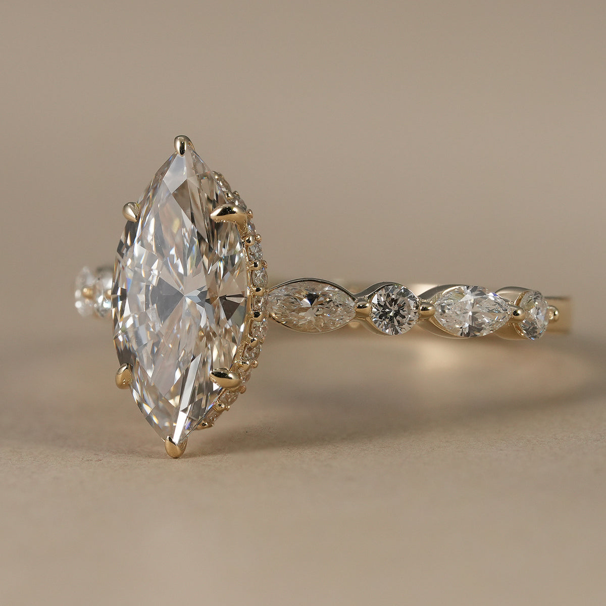 Elegant marquise diamond engagement ring featuring hidden halo and alternating side diamonds.