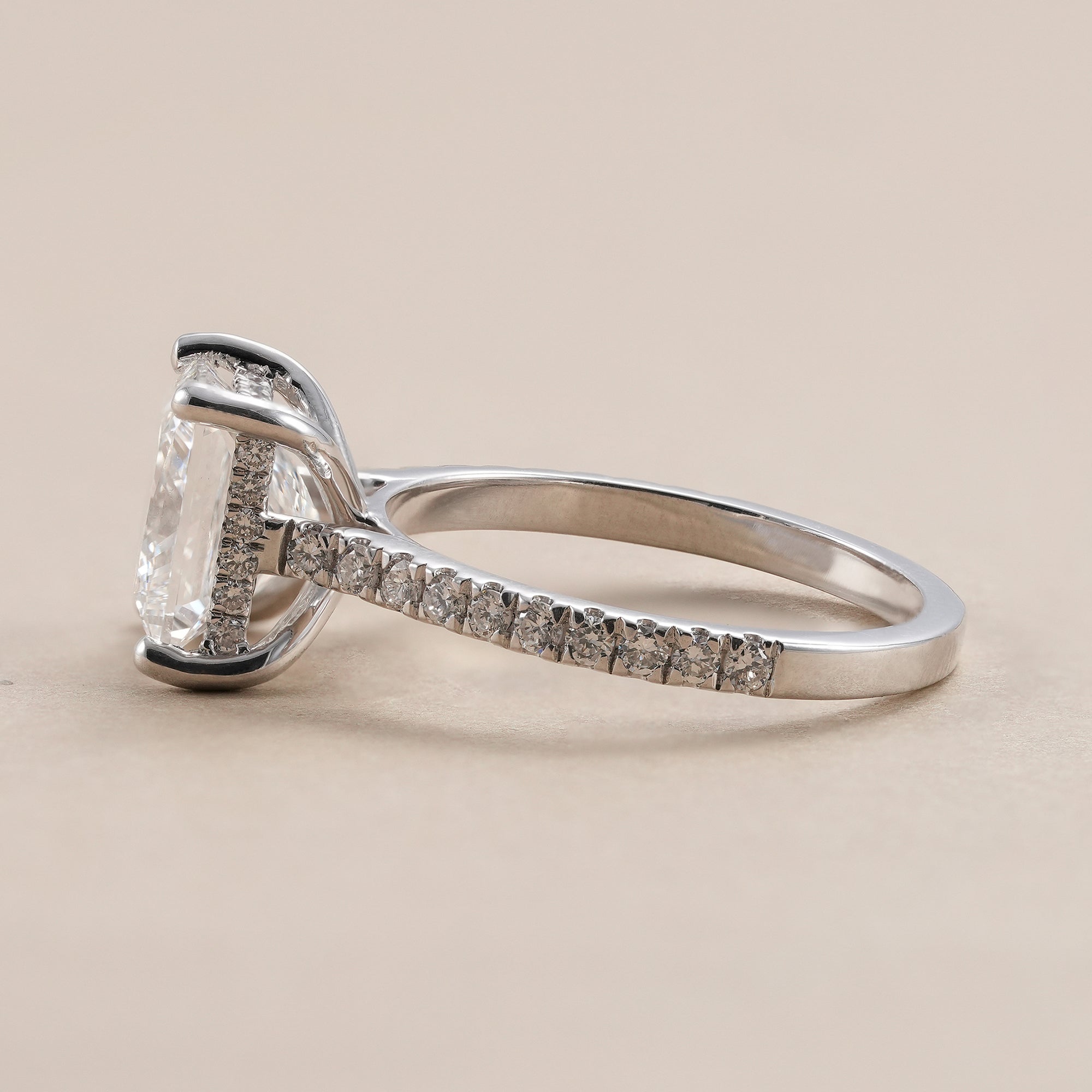Elegant hidden halo engagement ring featuring princess cut diamond.