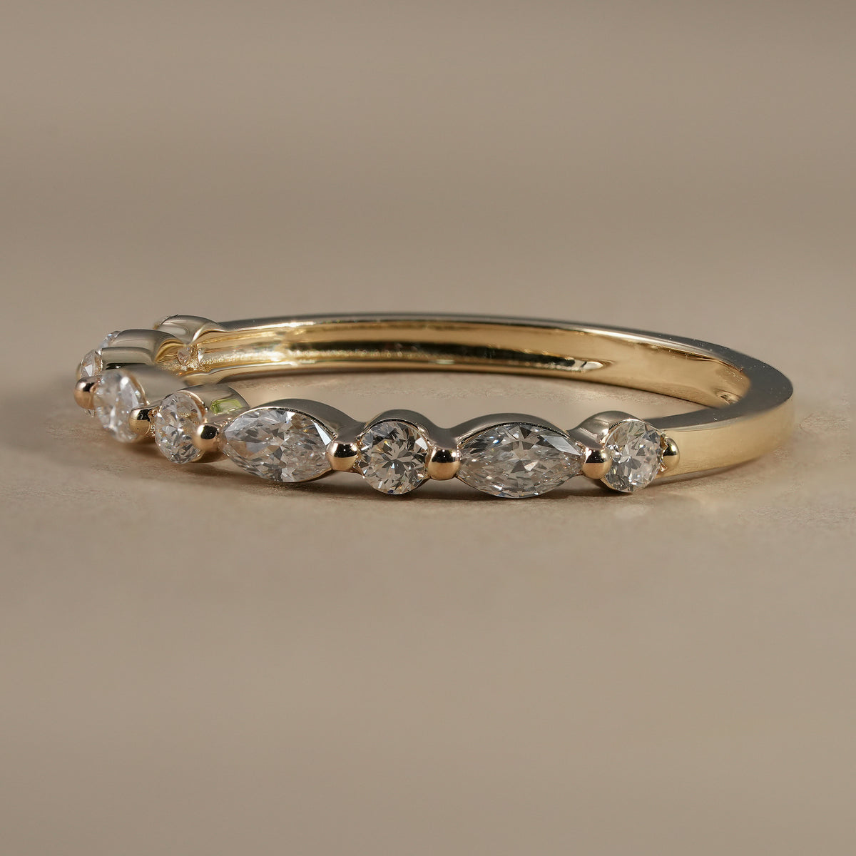 Elegant stackable lab diamond wedding band featuring alternating marquise and round diamonds.