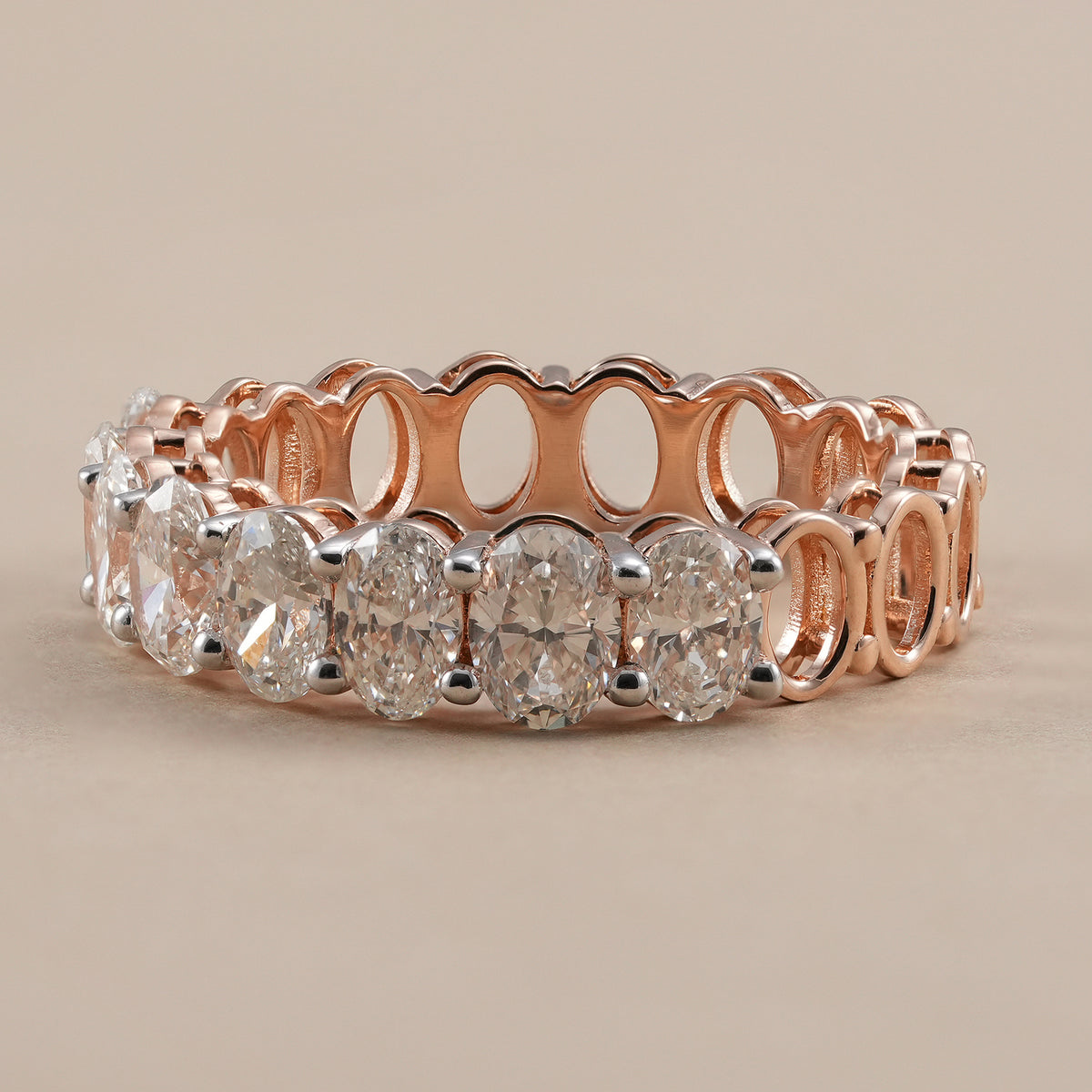 Full eternity oval diamond wedding ring with shared prong setting.