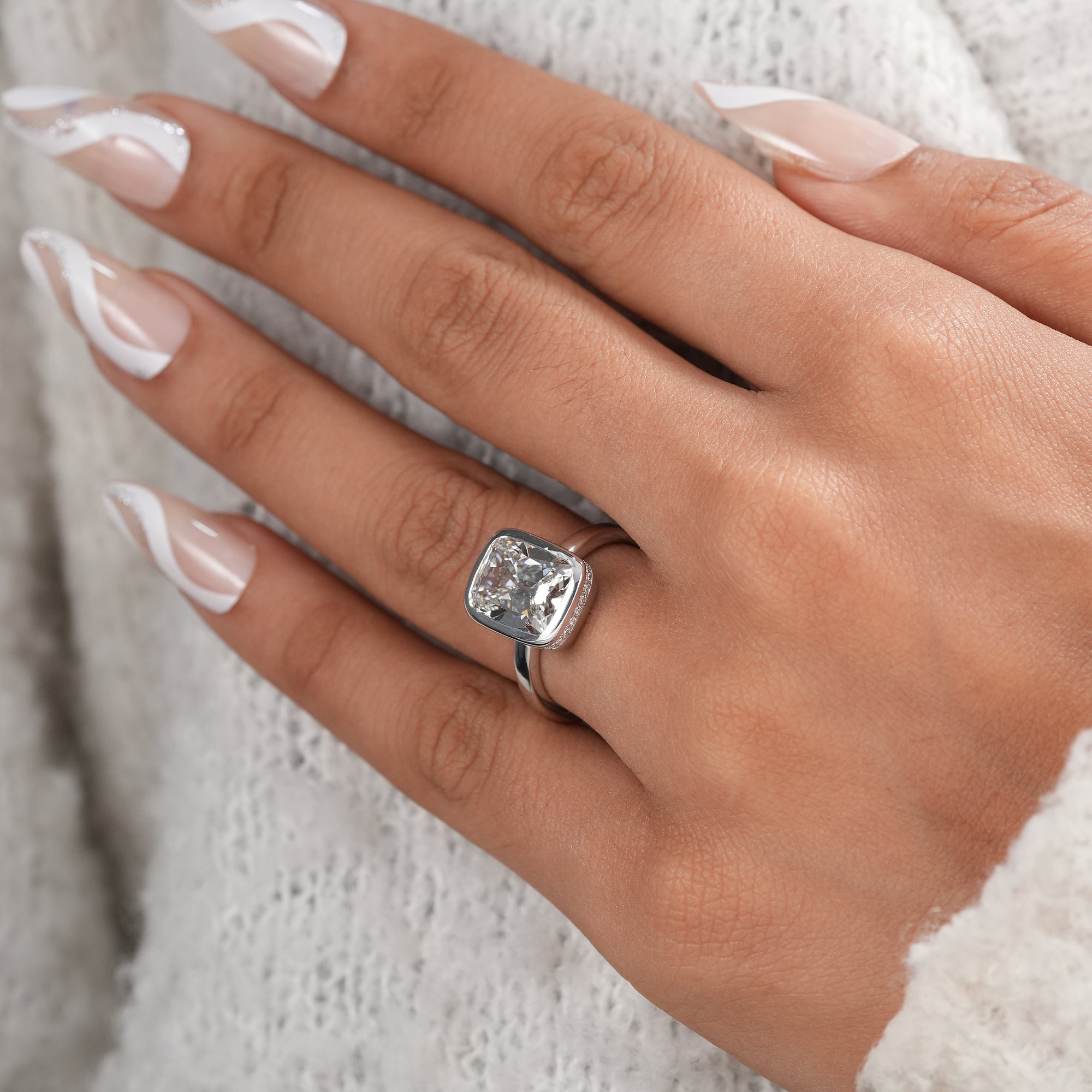 Luxury cushion cut lab grown diamond ring close-up.