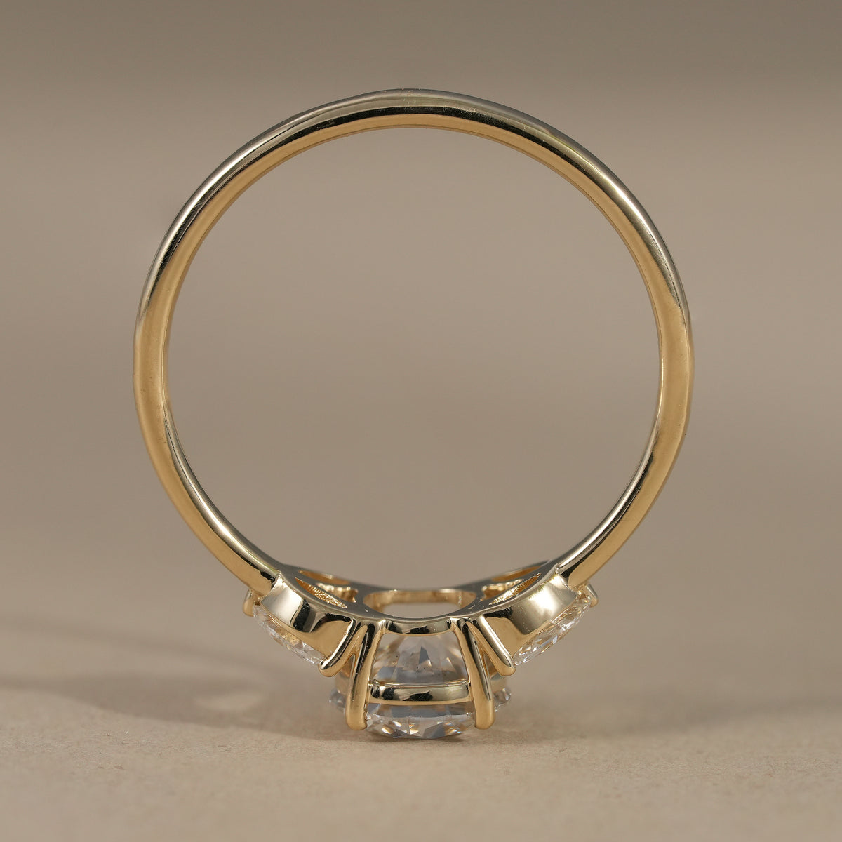 Round brilliant lab grown diamond ring featuring marquise cluster side stones.