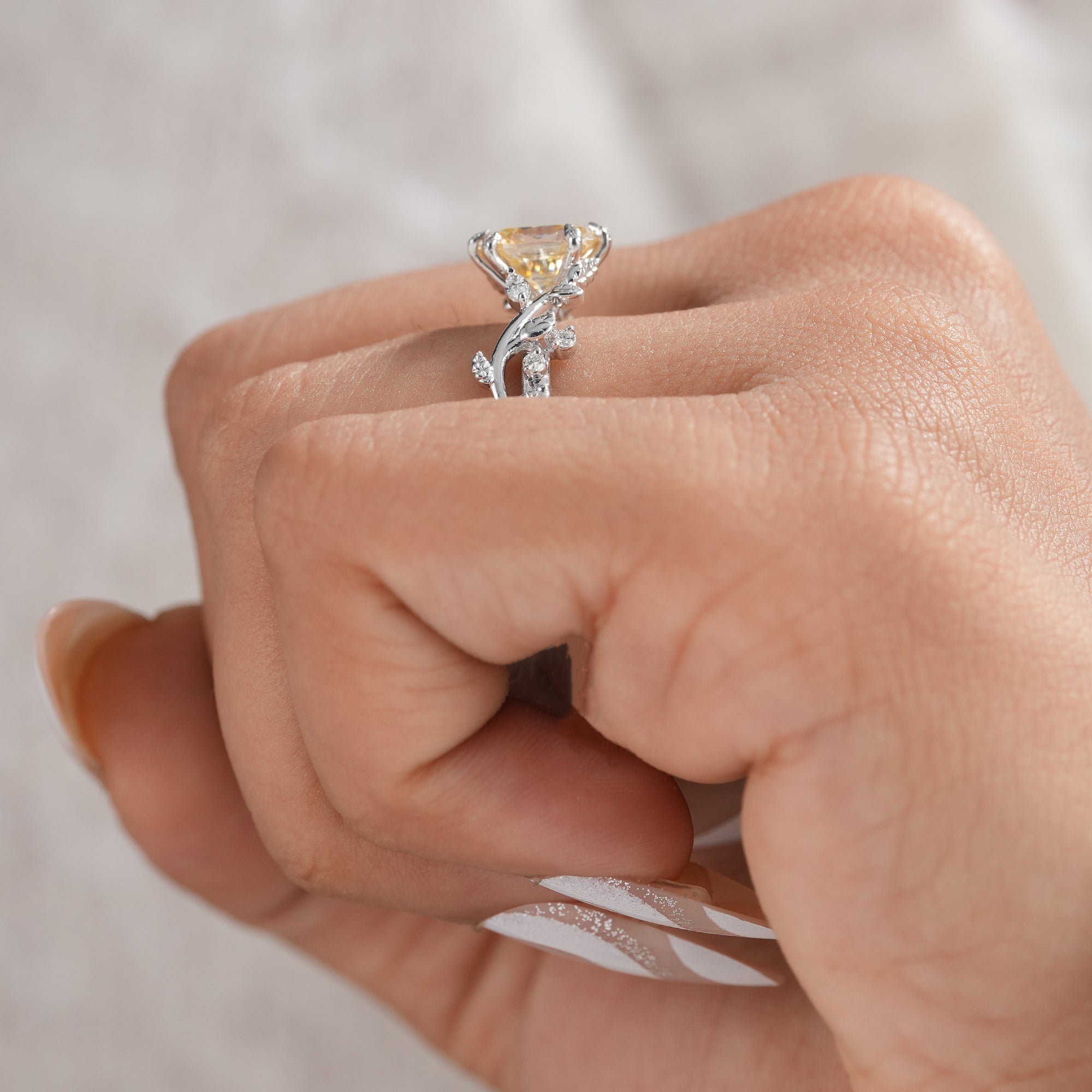 Romantic leaf band engagement ring with yellow center stone.