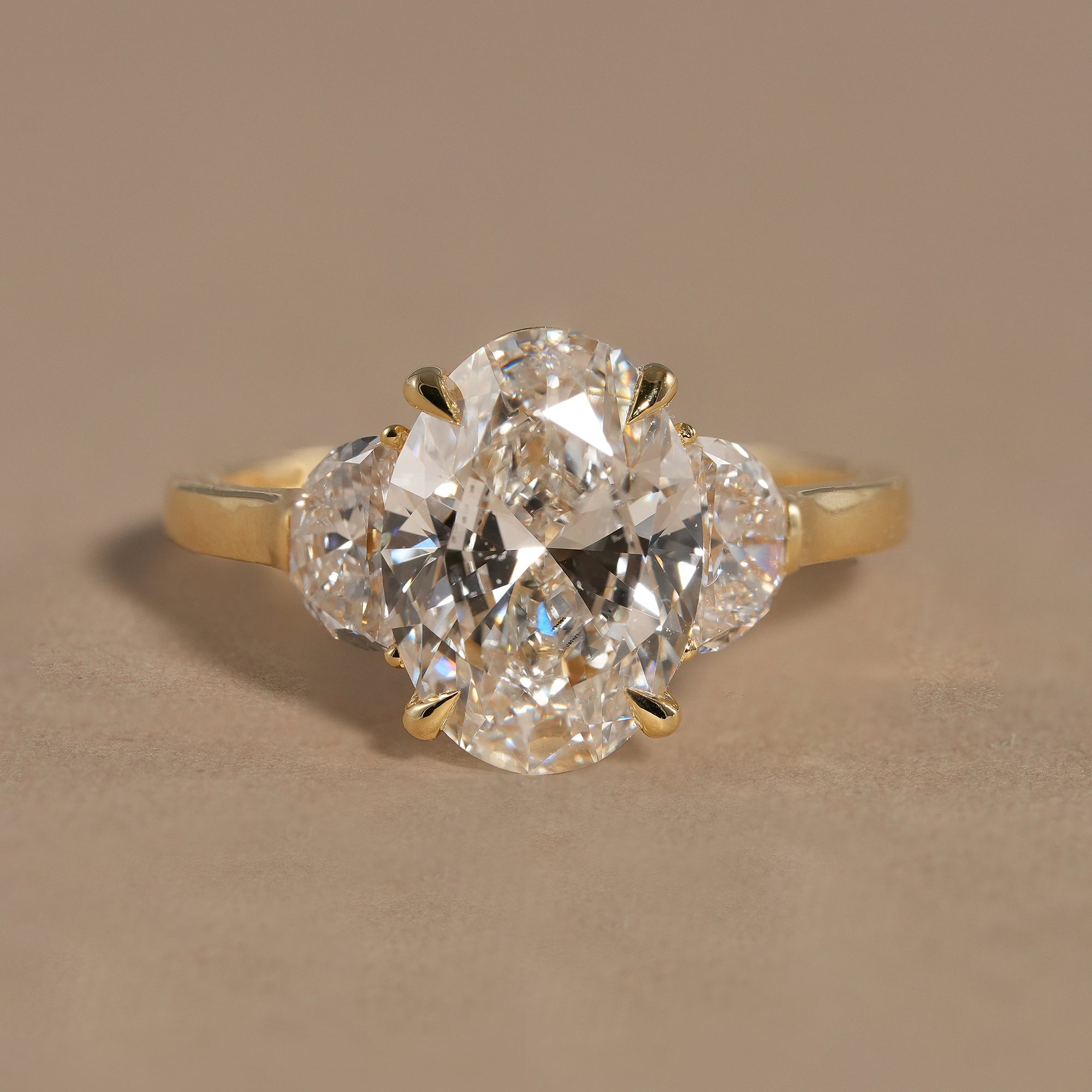 Oval lab grown diamond engagement ring with sparkling half moon side stones in solid gold