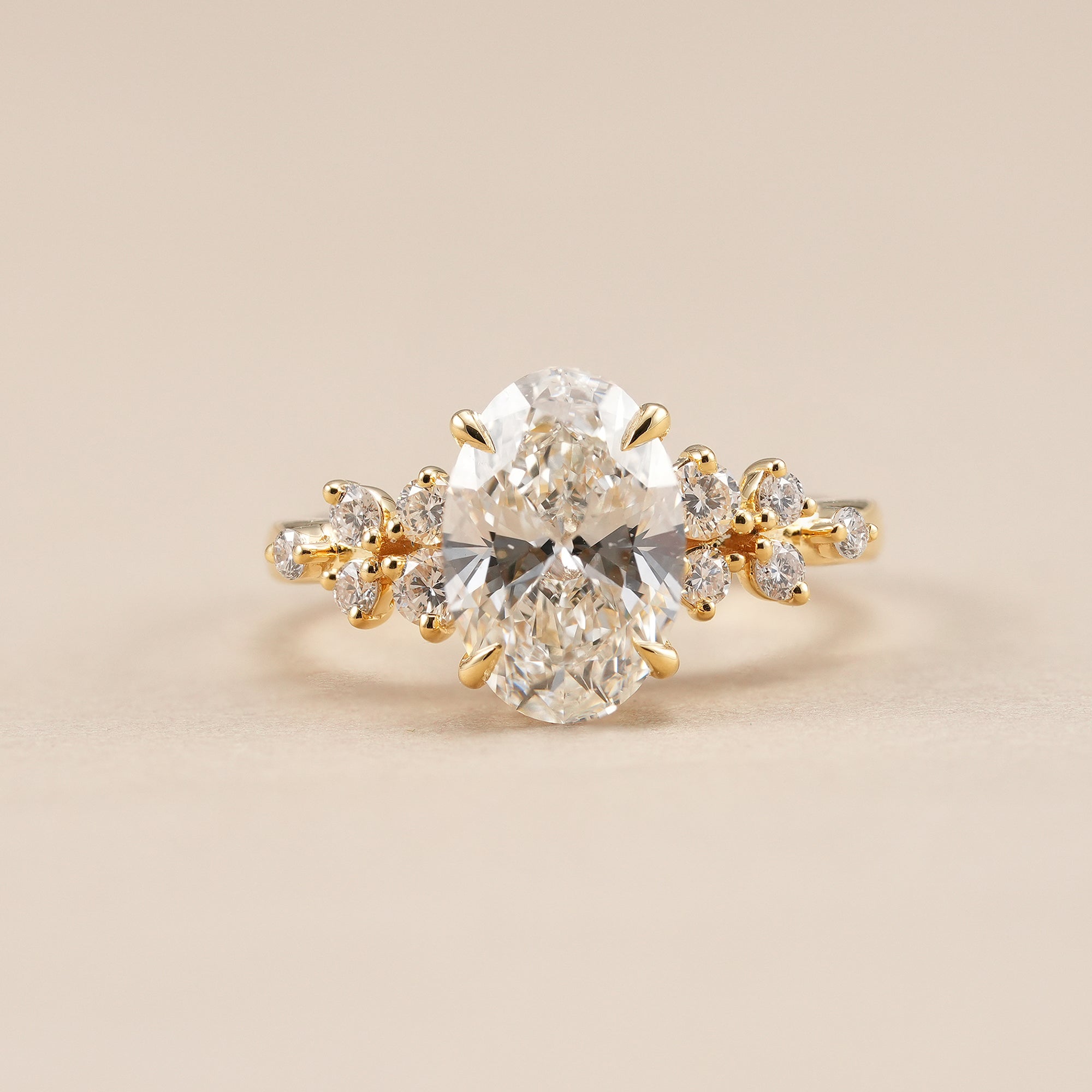 Oval lab grown diamond engagement ring with floral cluster side diamonds