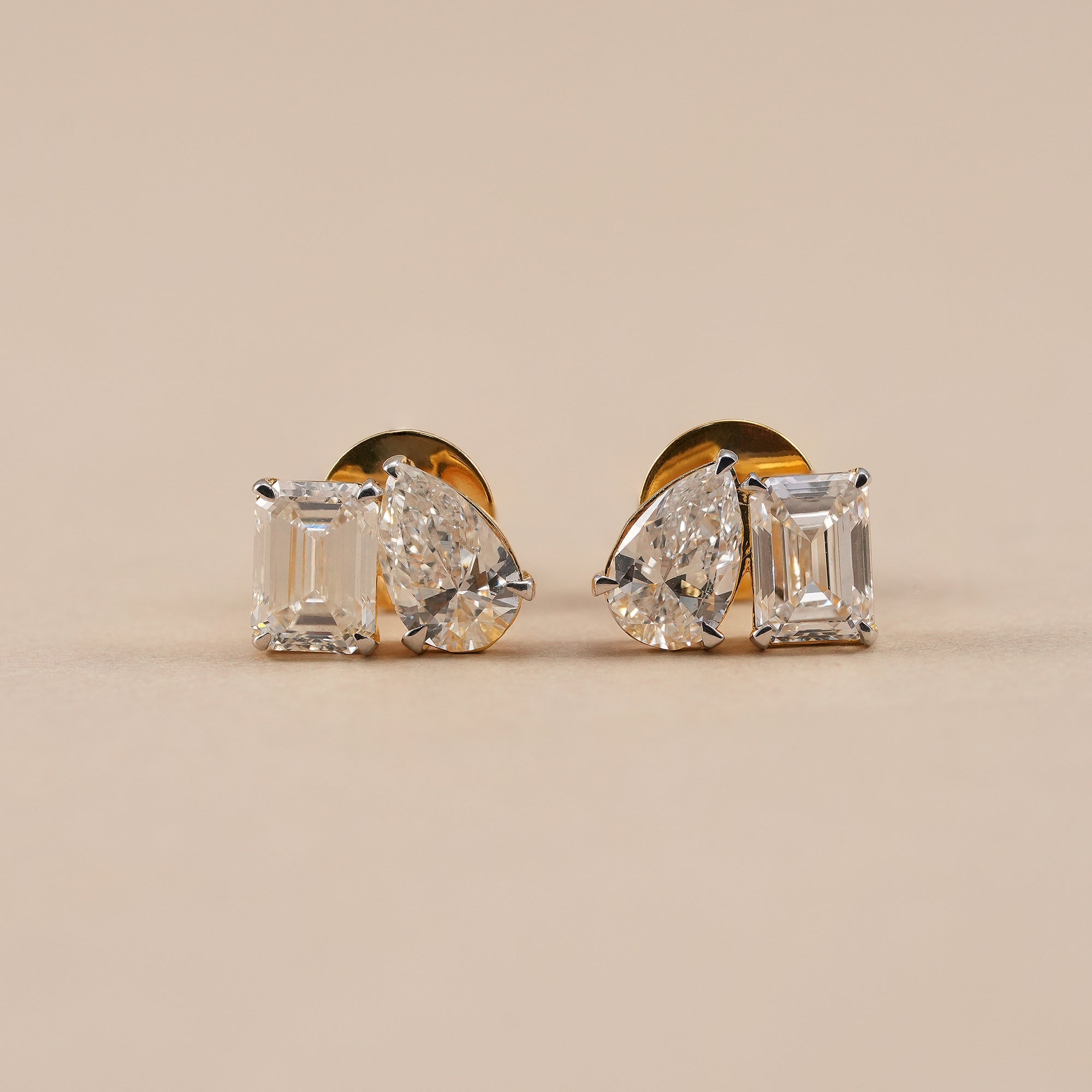 Toi Et Moi lab grown diamond stud earrings with emerald and pear diamonds