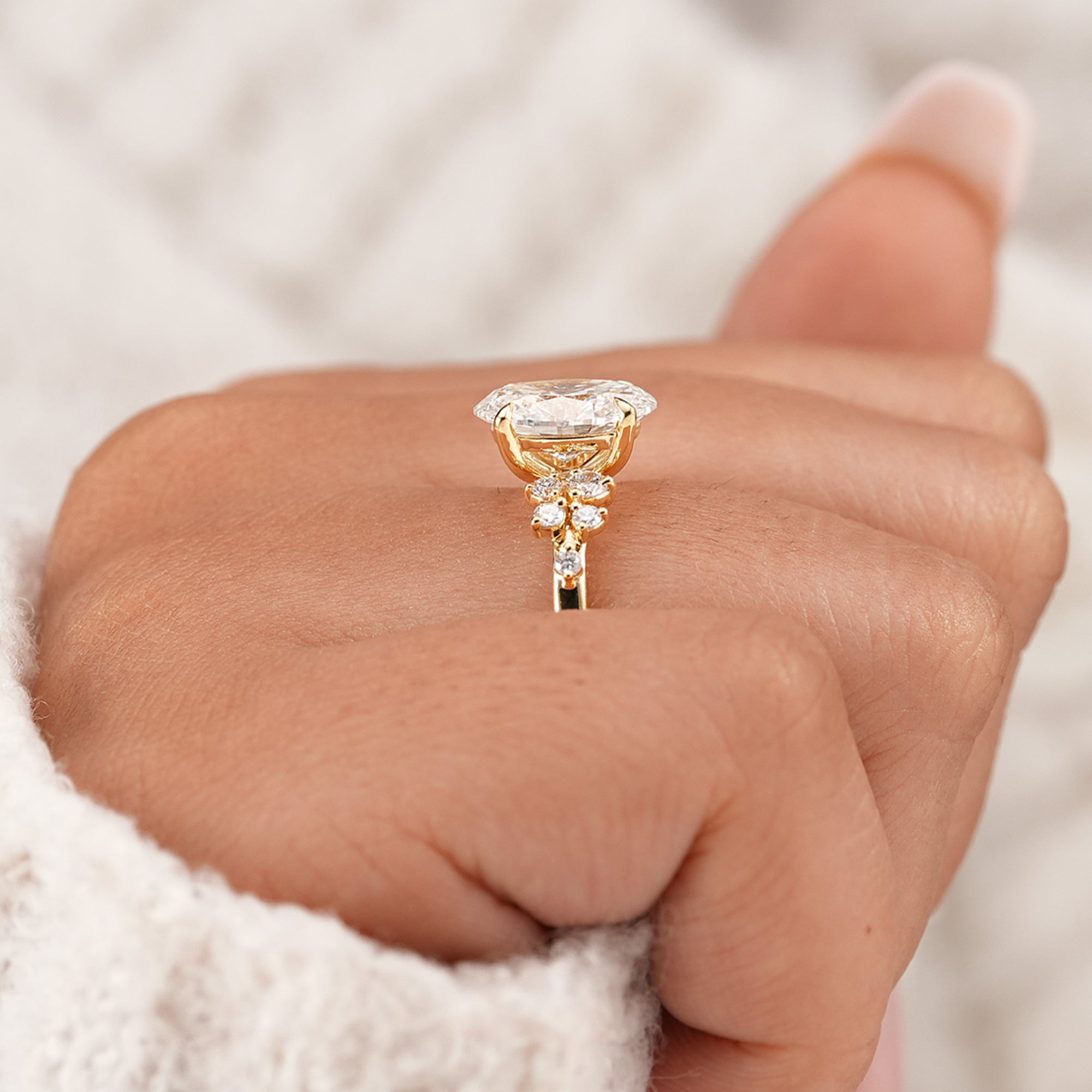 Oval proposal ring with floral inspired side stone setting