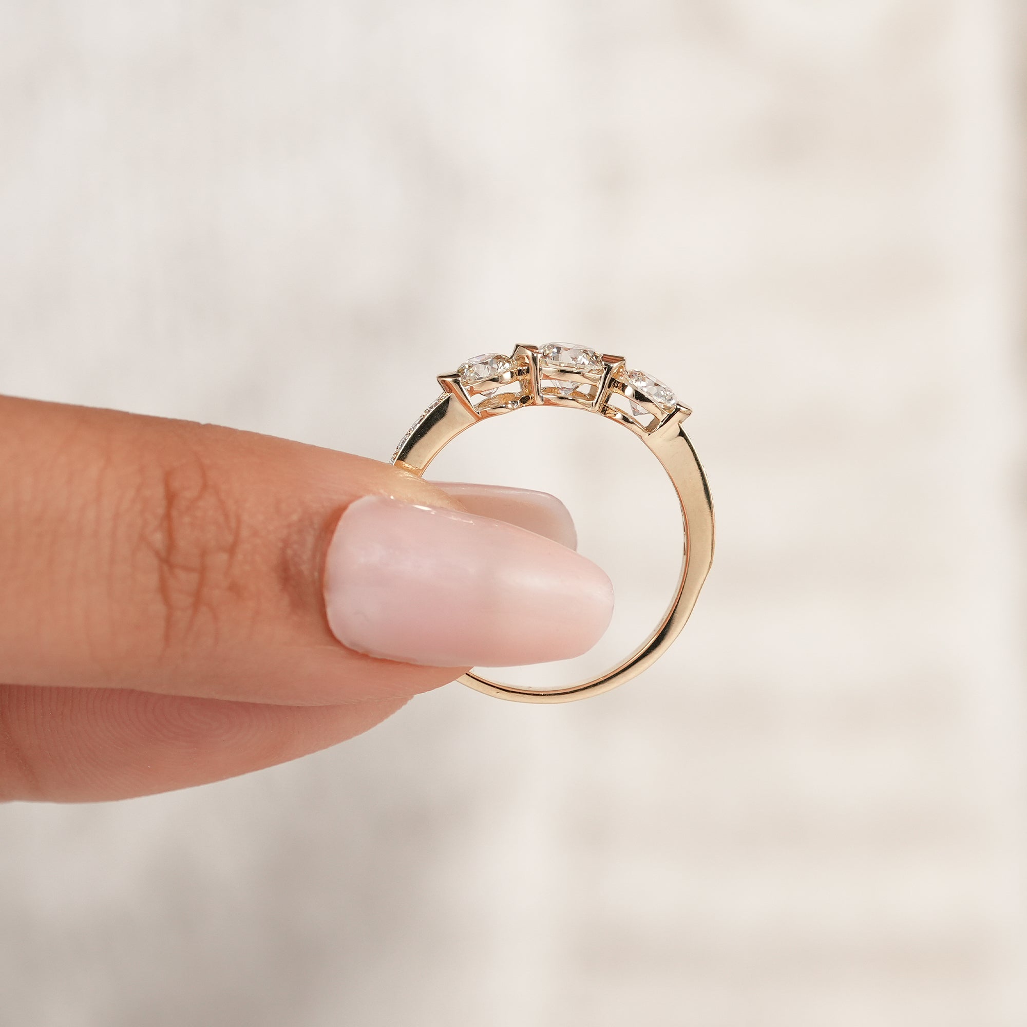 Minimalist round trilogy engagement ring in solid gold