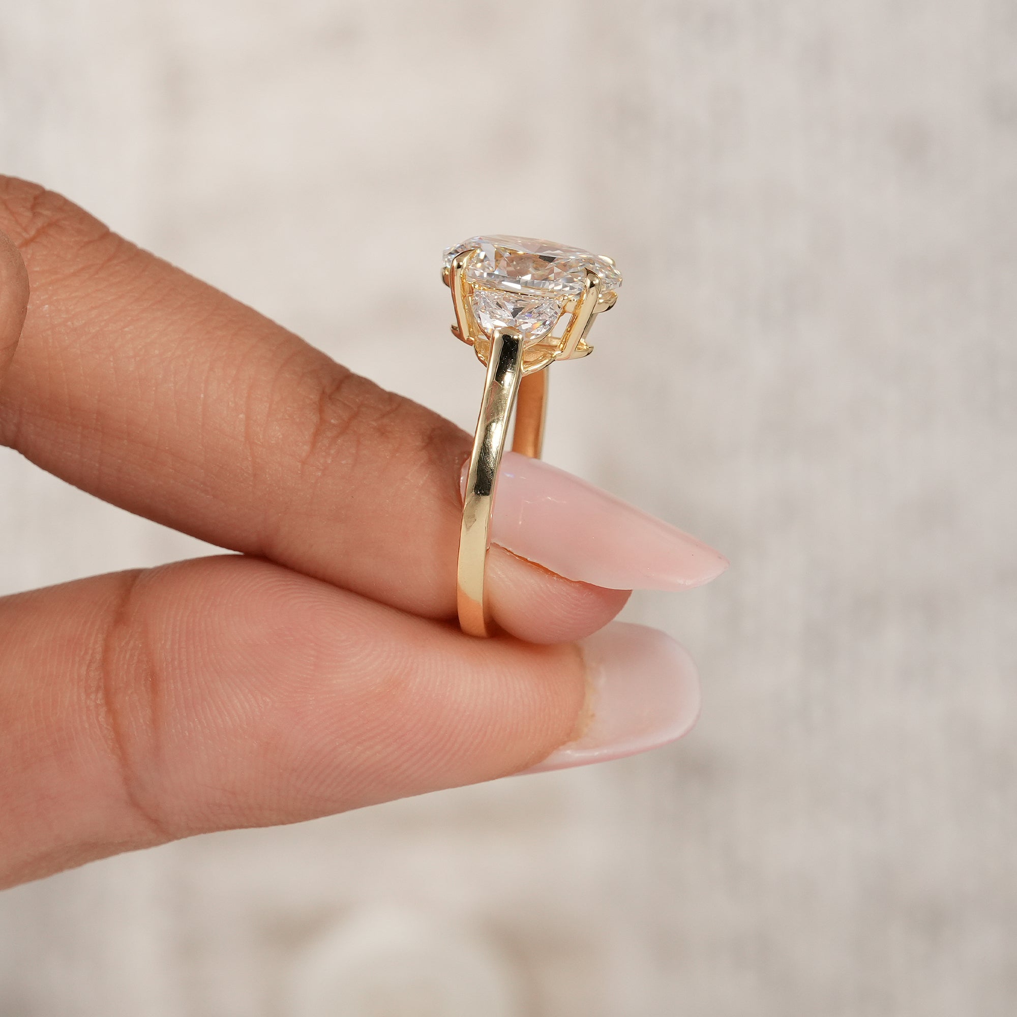 Classic oval diamond ring featuring elegant half moon side stone setting