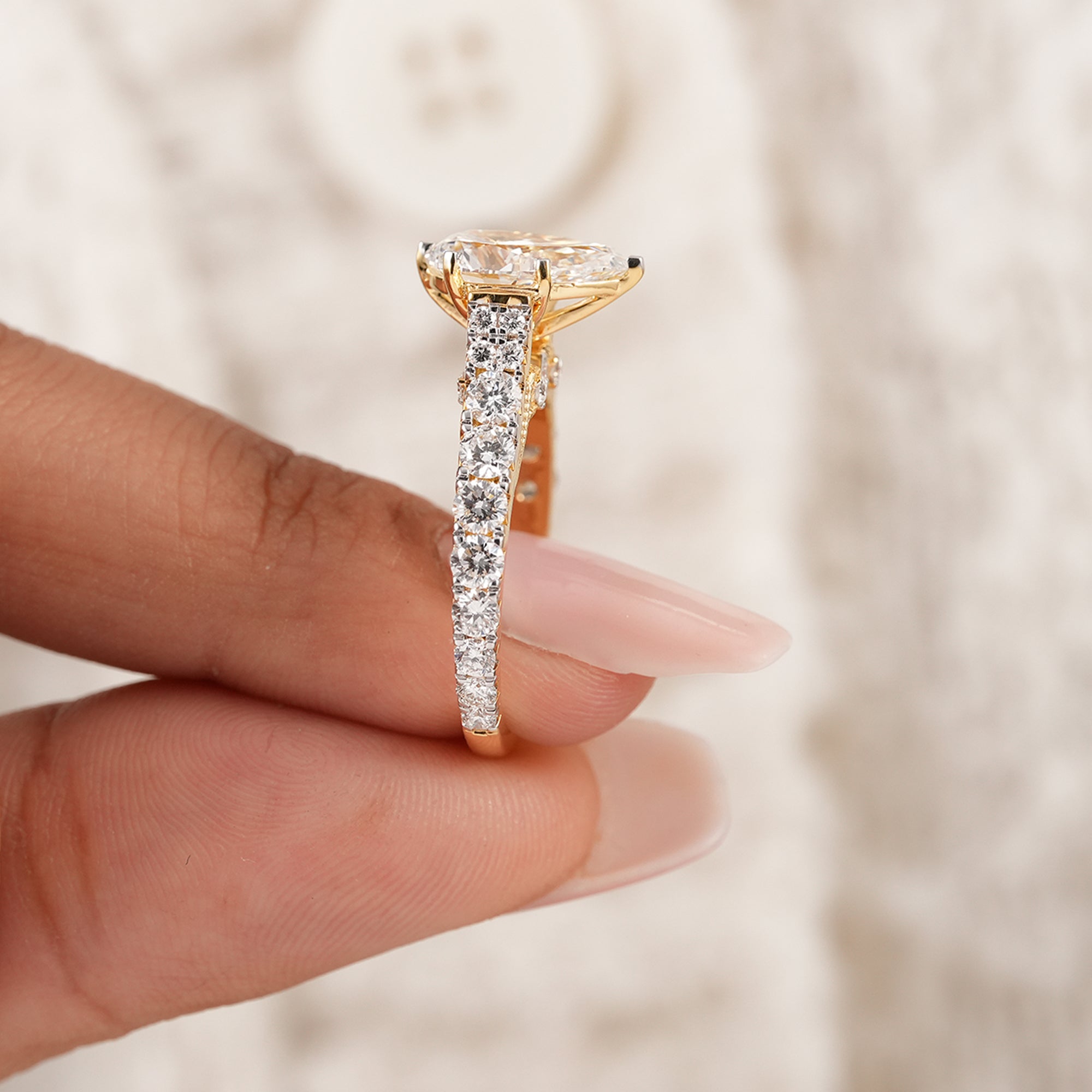Pear cut lab grown diamond ring with vintage engraved cathedral design
