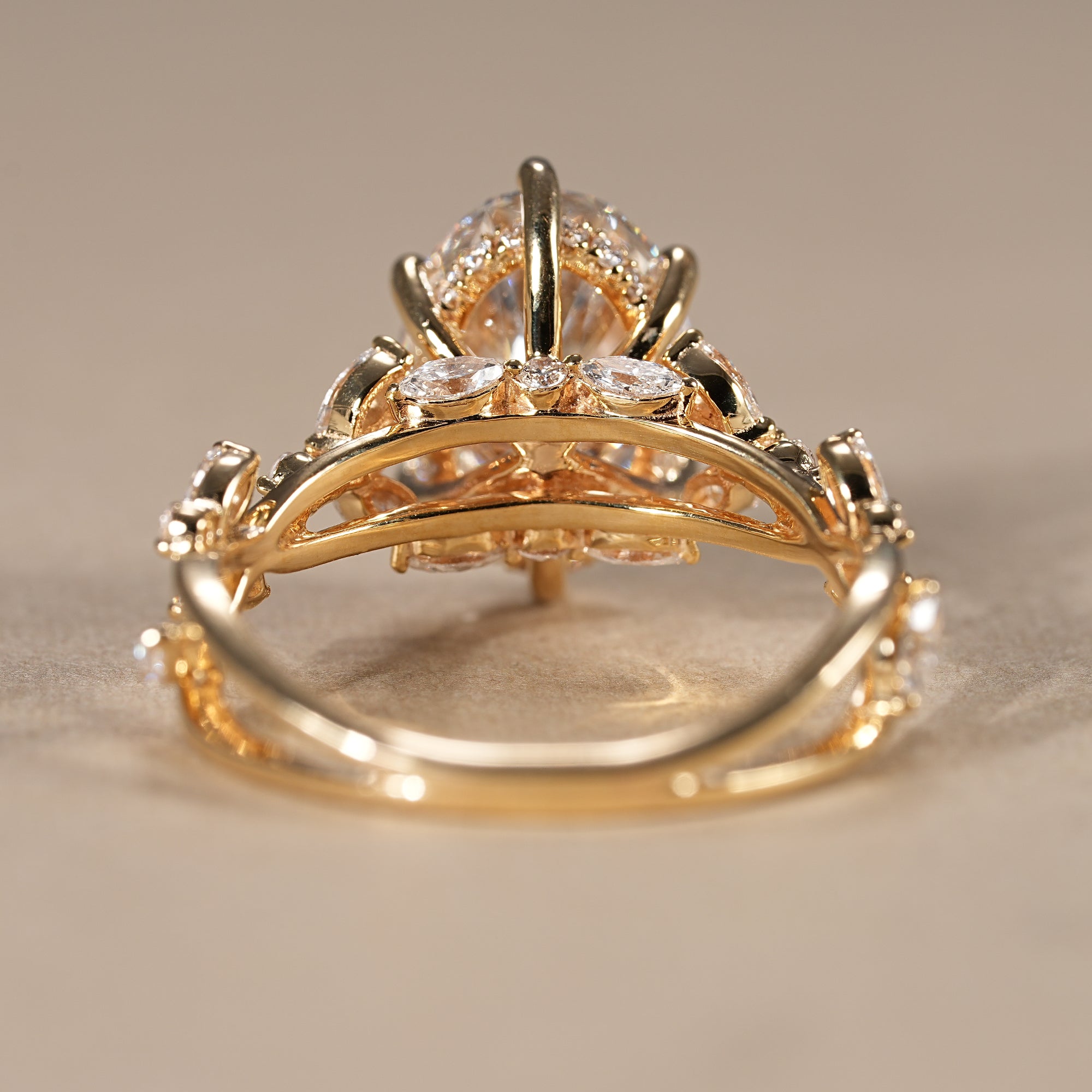Oval cut lab diamond ring with hidden halo and delicate floral leaf detailing