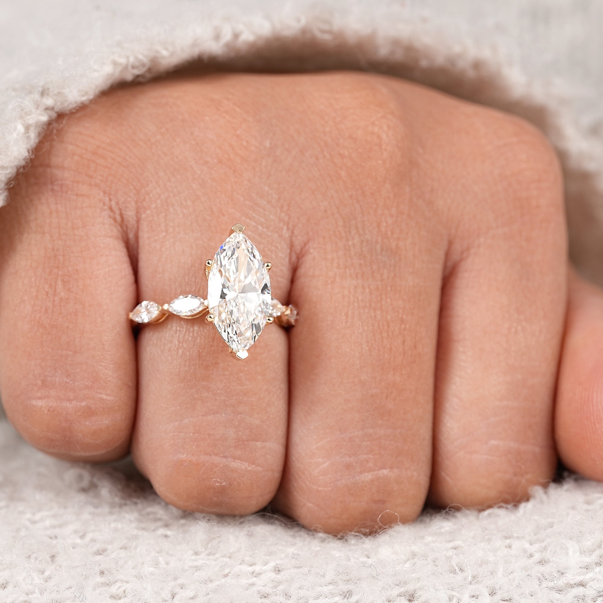 Minimalist marquise cut solitaire ring with marquise side diamond details