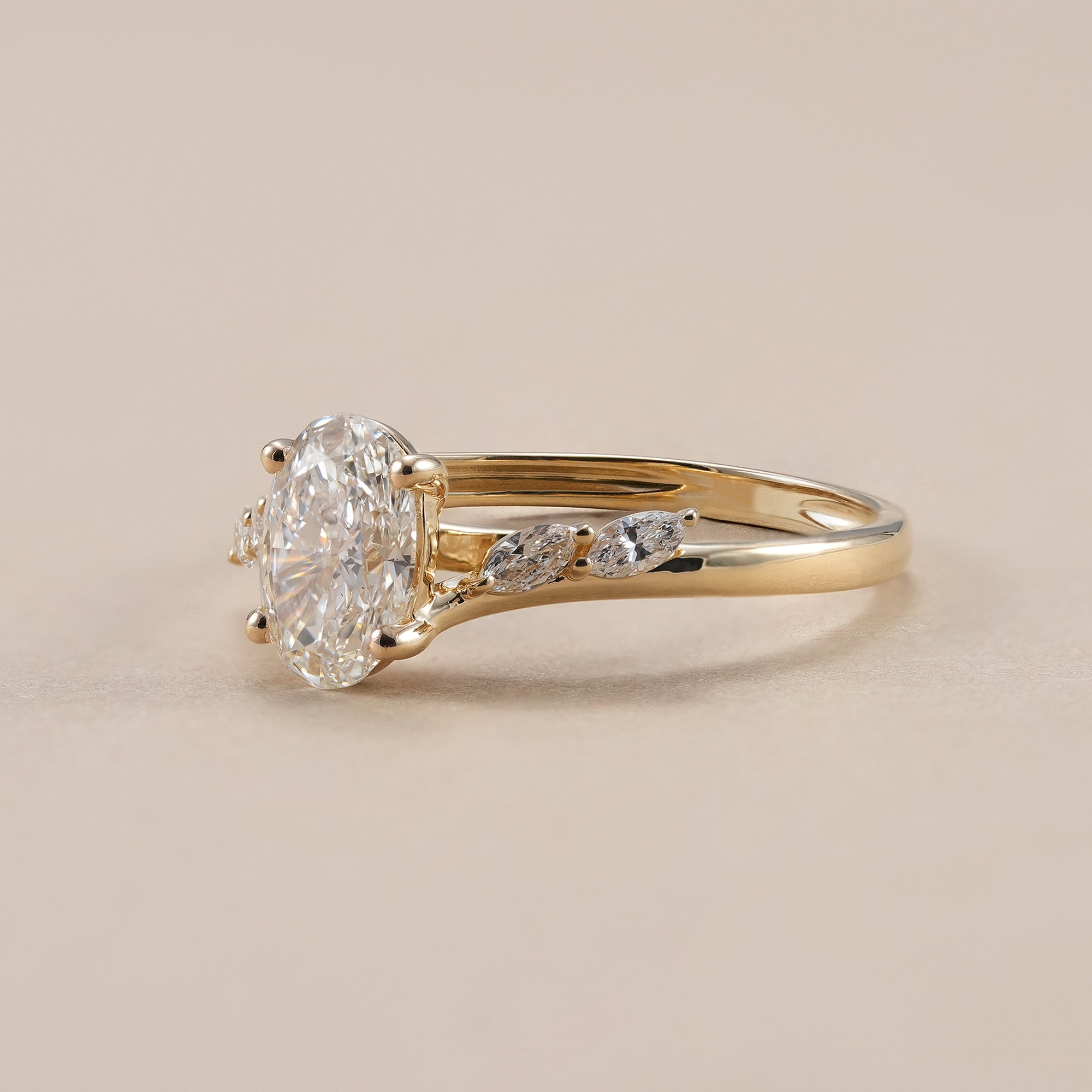 Oval lab grown diamond ring featuring leaf inspired marquise diamond band.