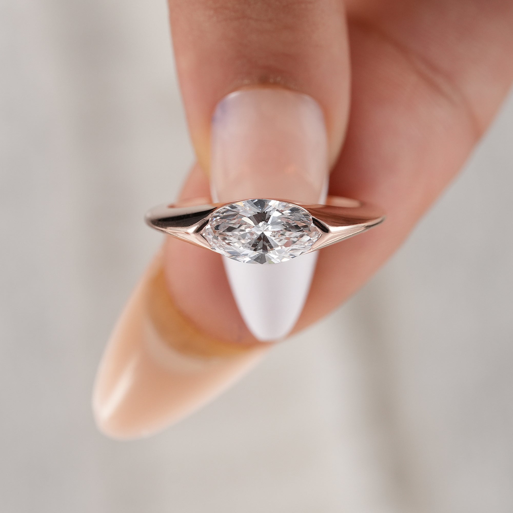 Luxury marquise diamond engagement ring with half bezel design.
