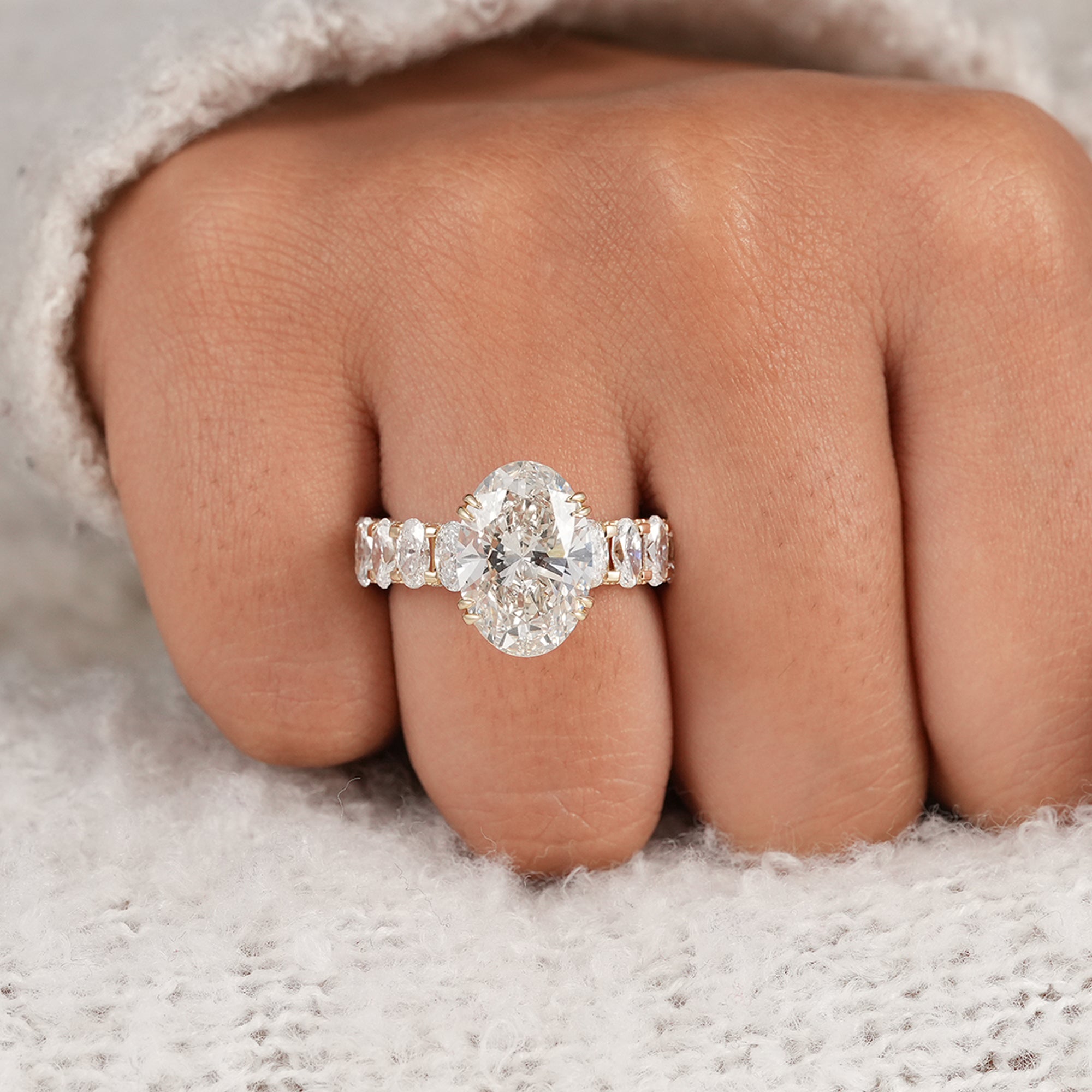 Hidden halo oval engagement ring showcasing a brilliant 5 CT lab grown diamond centerpiece.
