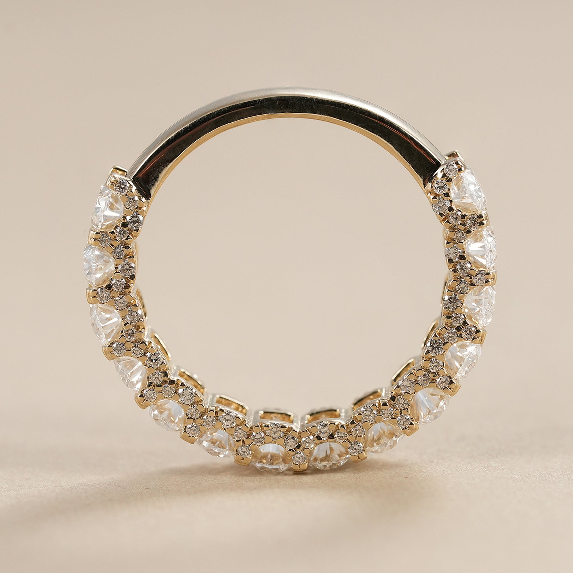 Elegant oval diamond eternity band with continuous lab grown diamonds set in solid gold.