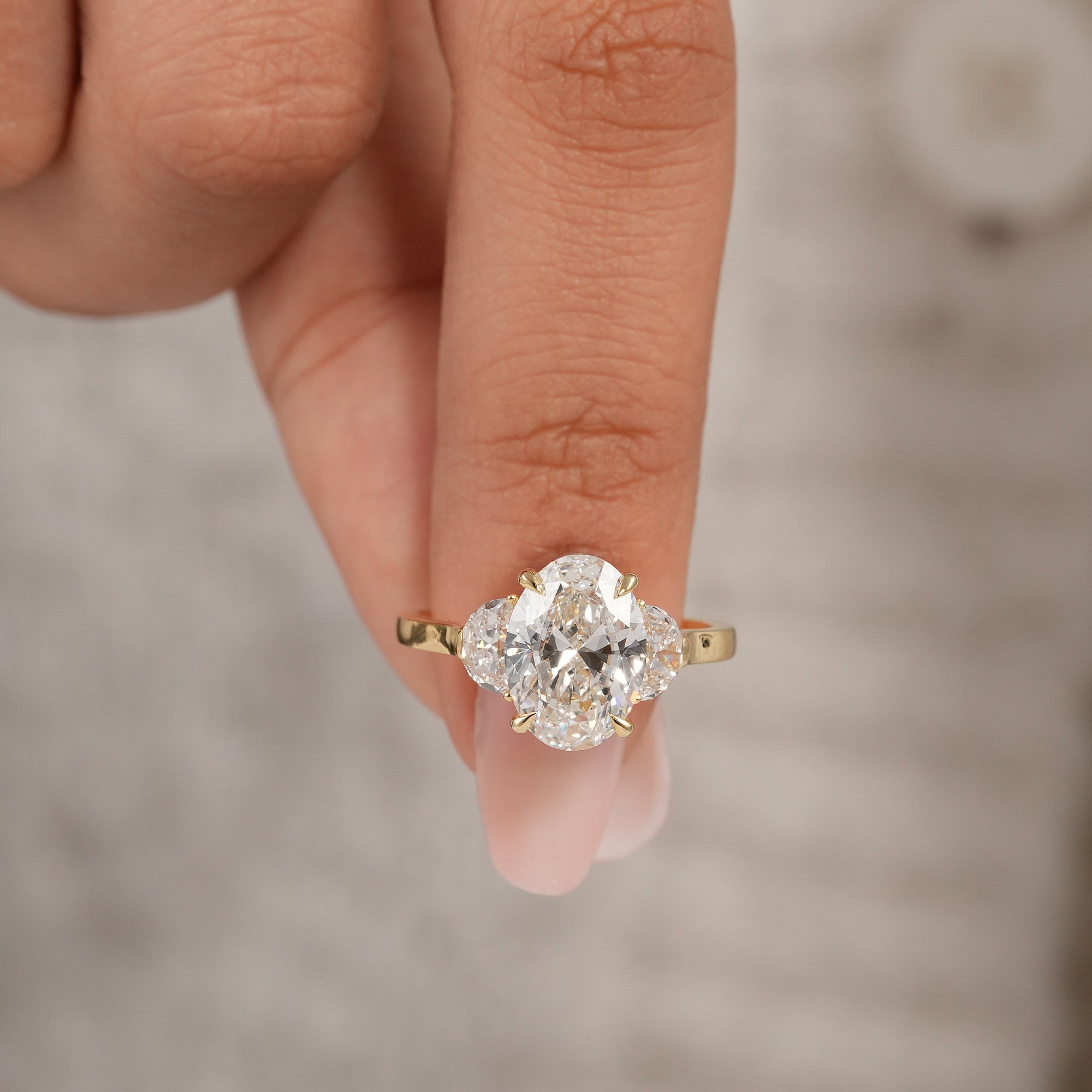 Three stone oval lab diamond ring featuring brilliant half moon accent diamonds