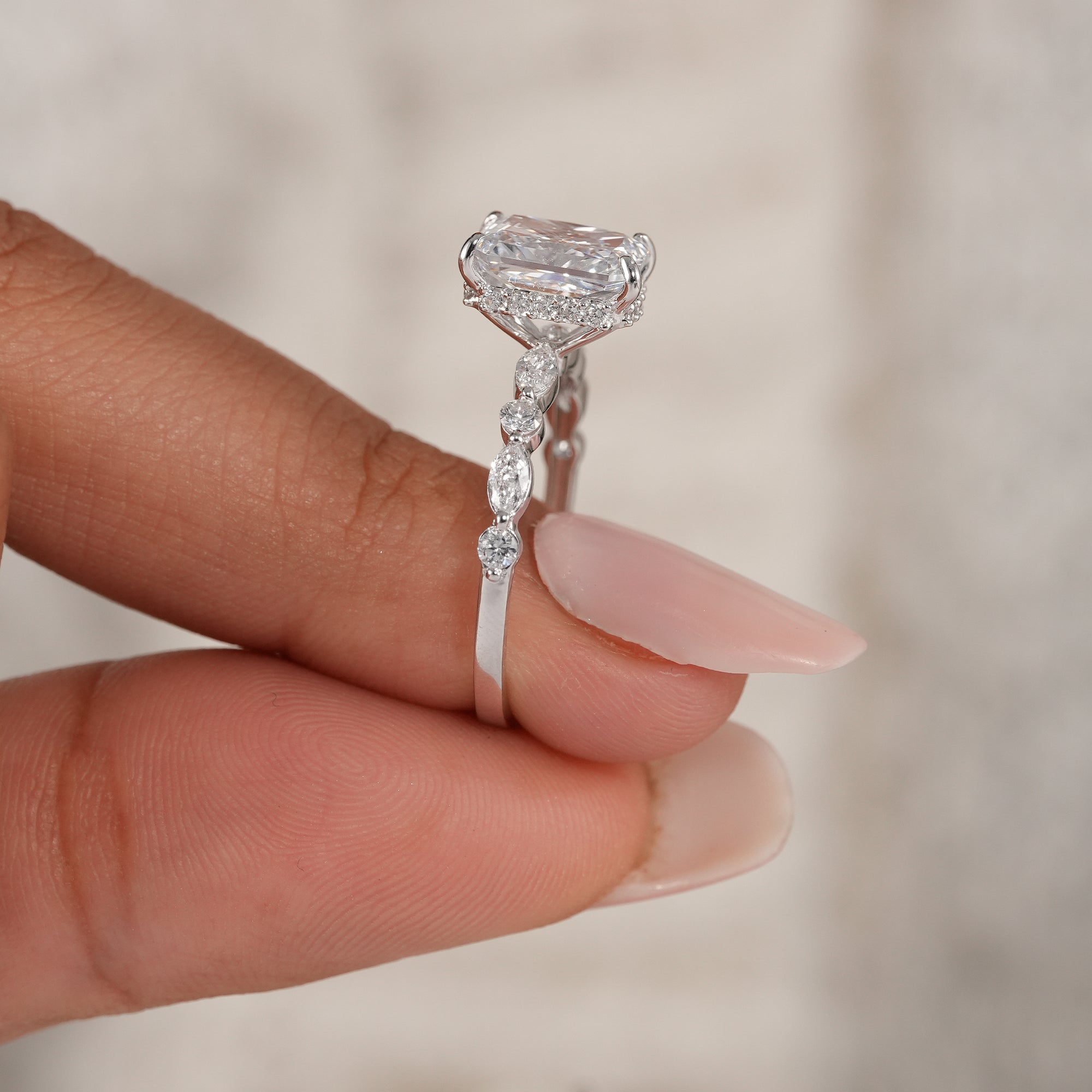Four prong radiant diamond ring with hidden halo.