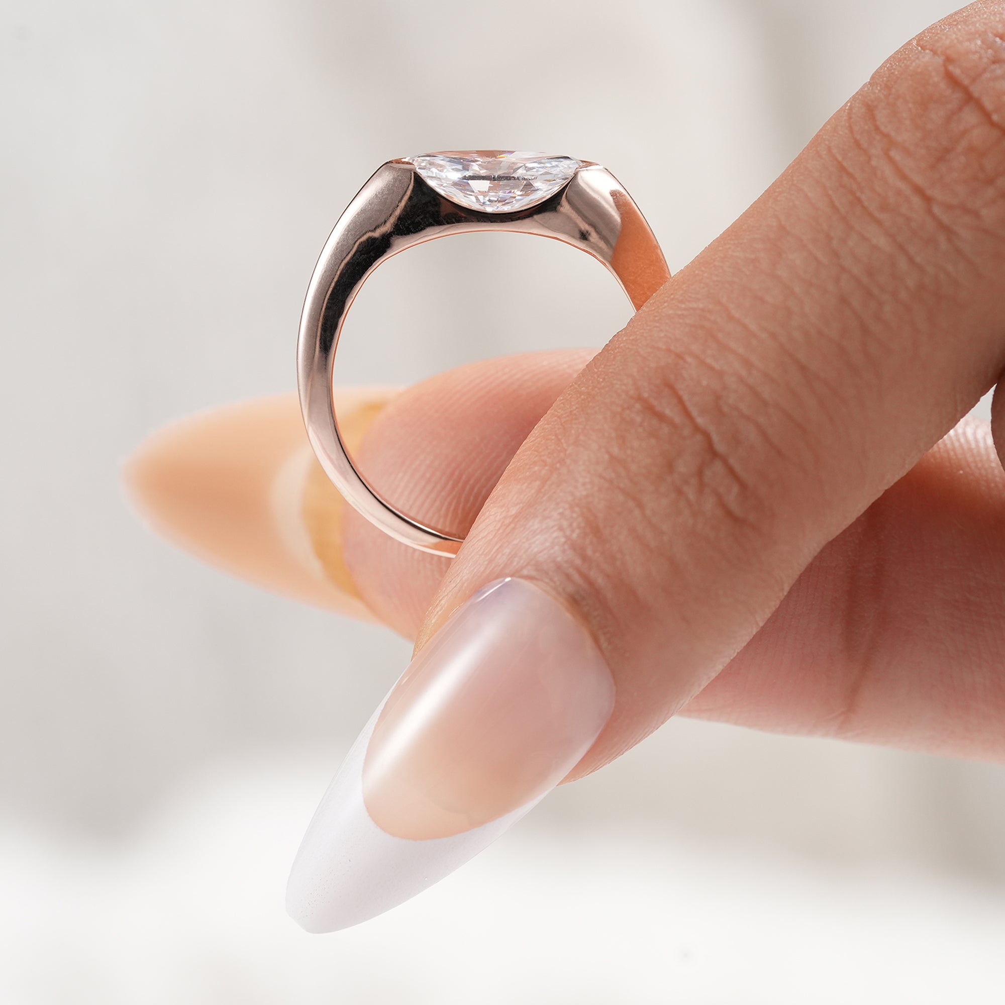 Wedding jewelry with marquise diamond half bezel setting.