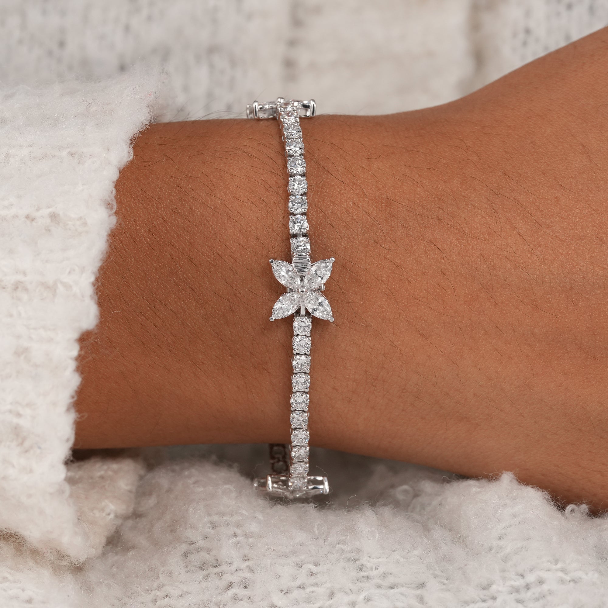 Women's lab diamond bracelet with floral butterfly accents.