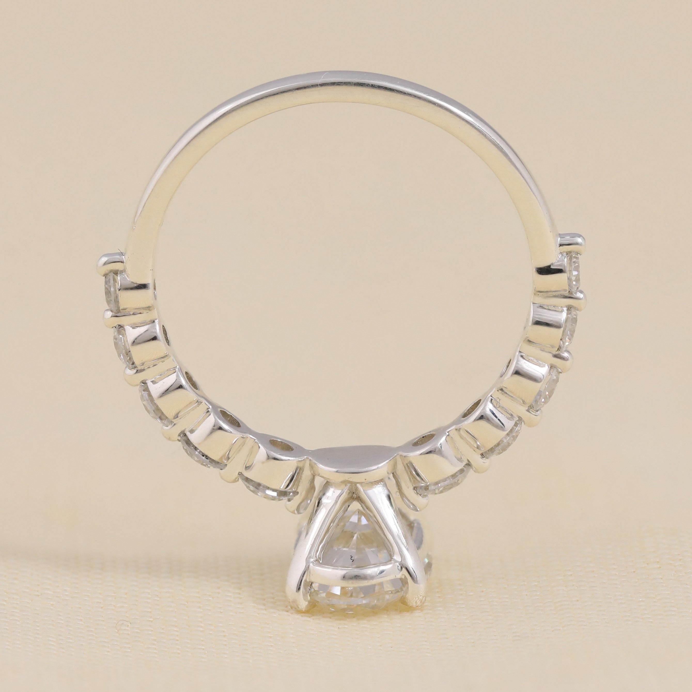 Modern side-stone engagement ring with a central oval lab-grown diamond