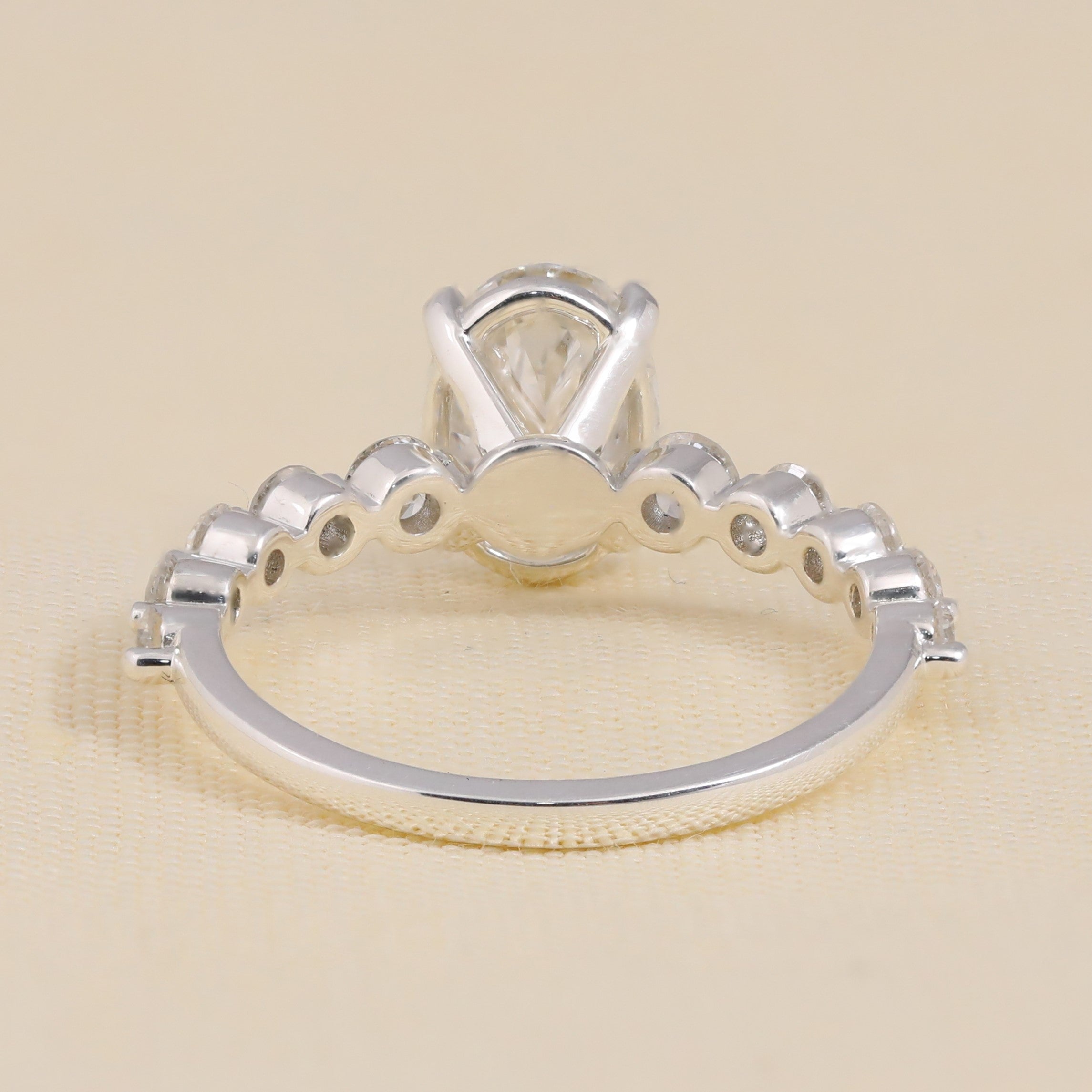 Oval lab-grown diamond engagement ring with side stones in a classic setting