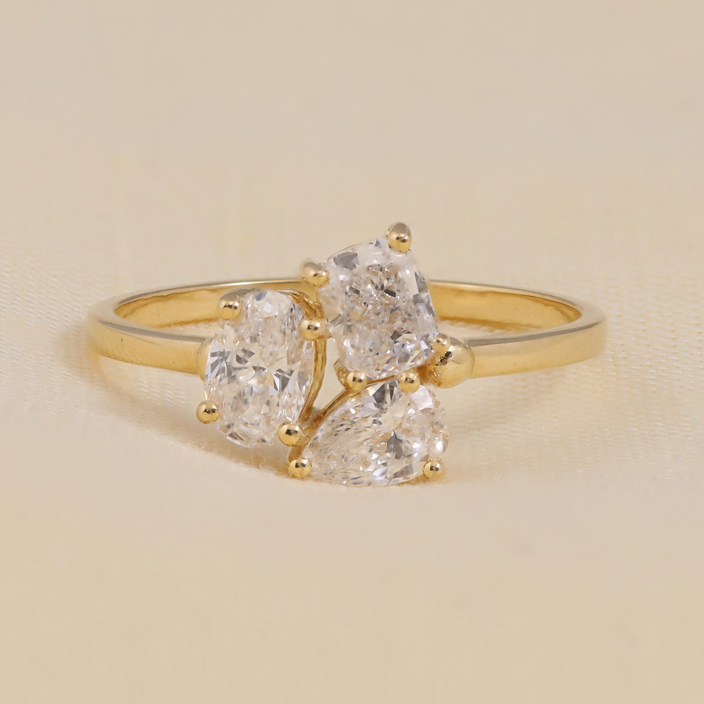 Three-stone ring featuring oval lab grown diamond center shapes in an elegant setting