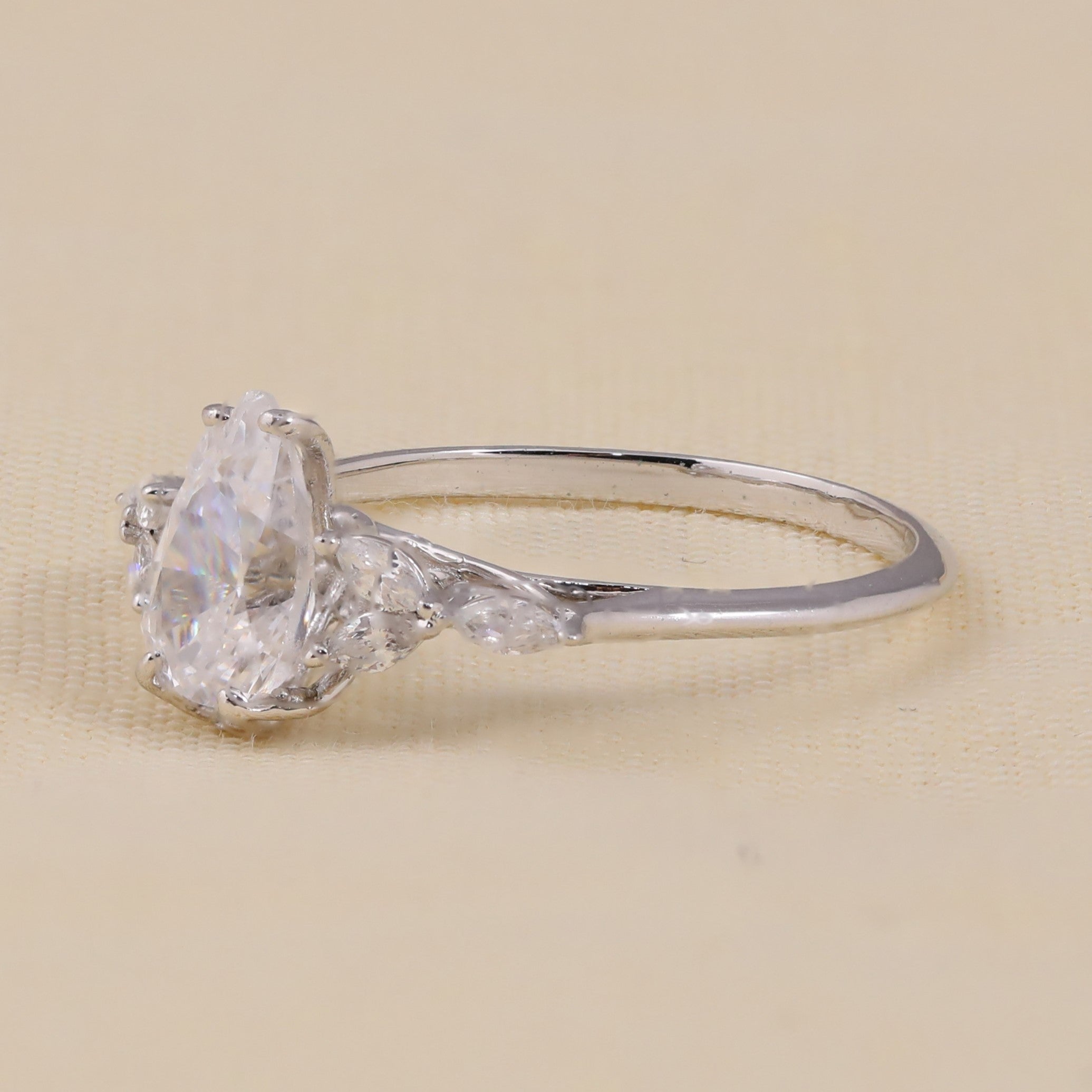 Teardrop lab grown diamond ring with floral marquise accents for women.