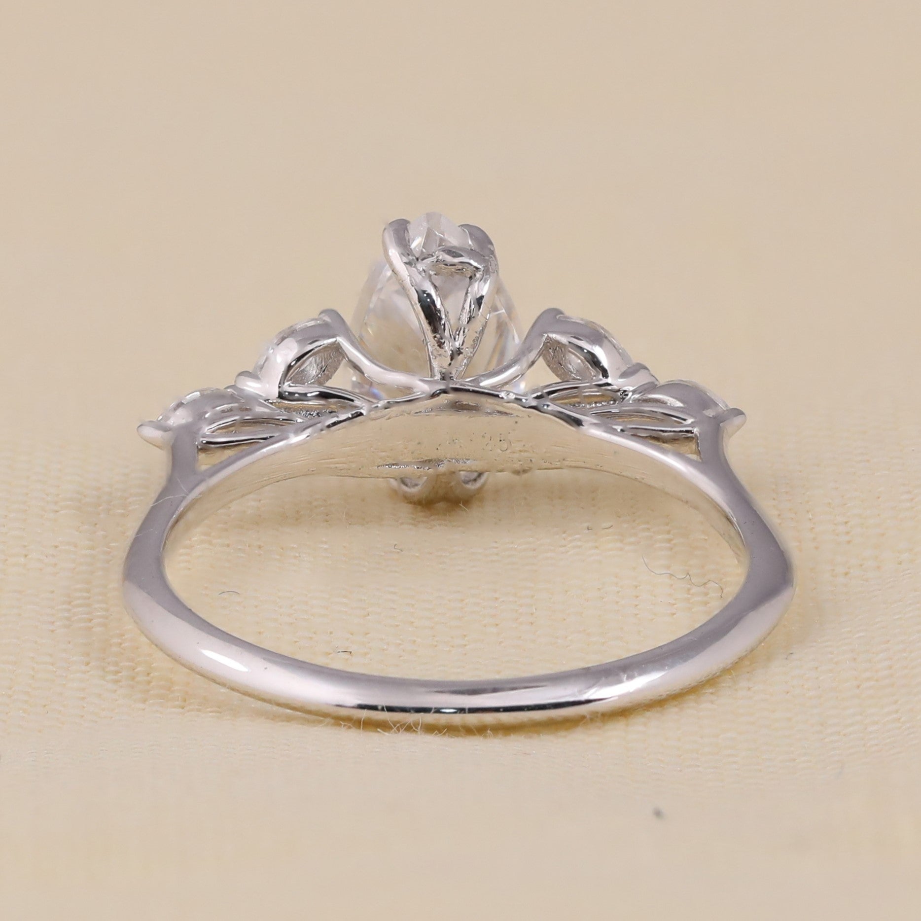 Elegant pear shaped lab diamond ring with marquise side diamonds on thin band.
