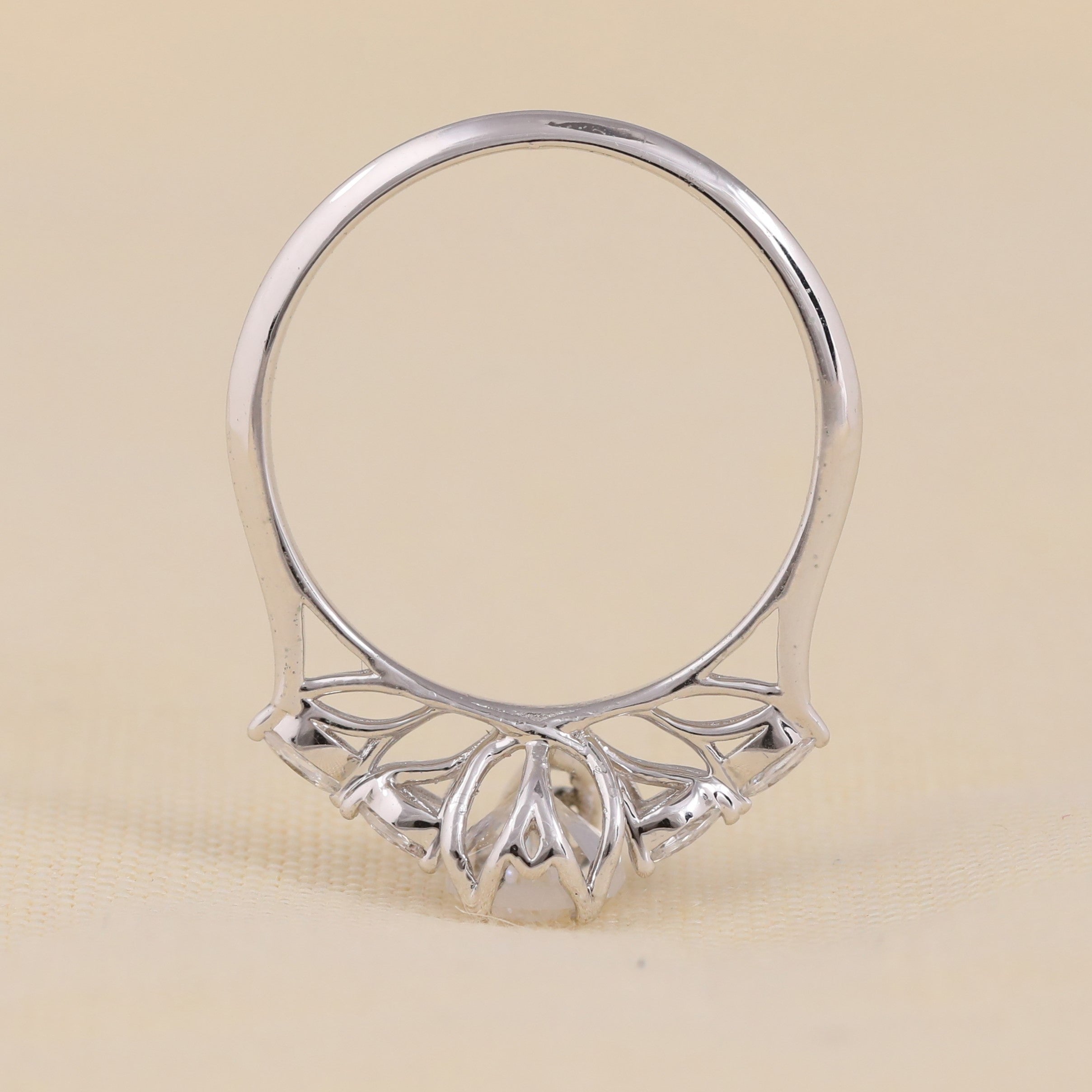 Lab grown pear diamond solitaire ring with marquise leaf style side stones.