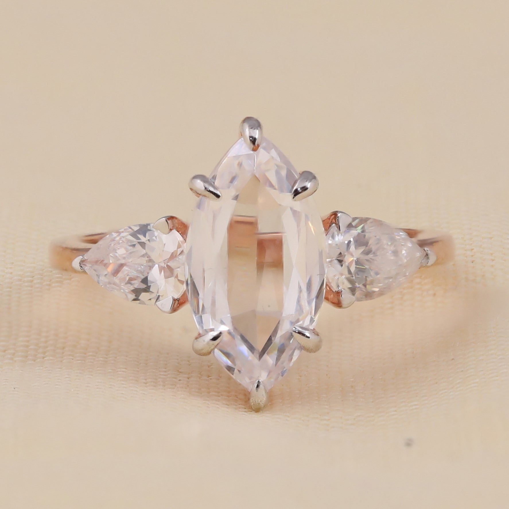 Marquise cut center stone engagement ring with pear side stones for proposal
