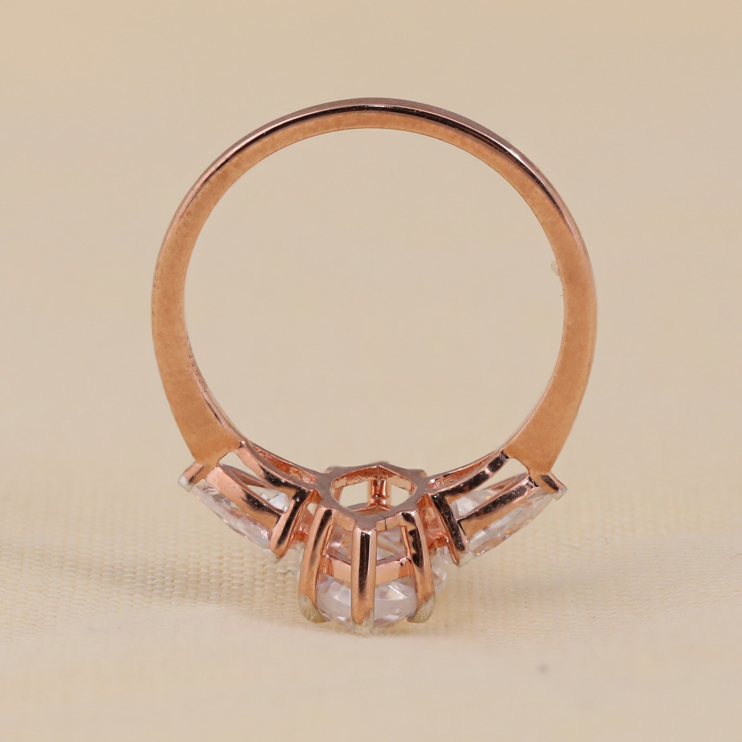 Modern three stone engagement ring featuring marquise center diamond style