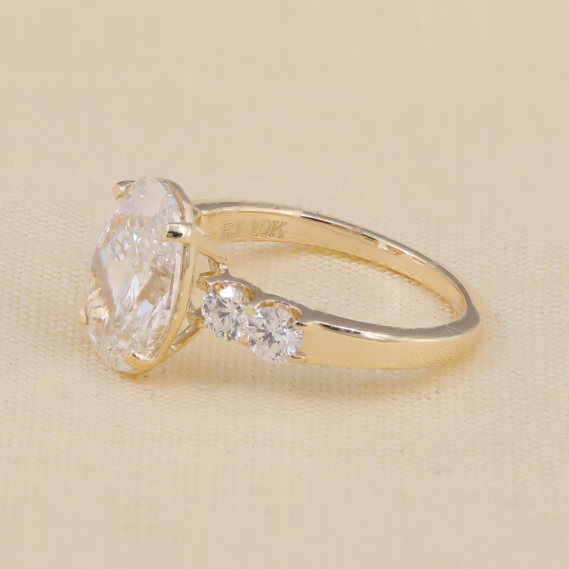 Lab grown oval engagement ring with round accent stones