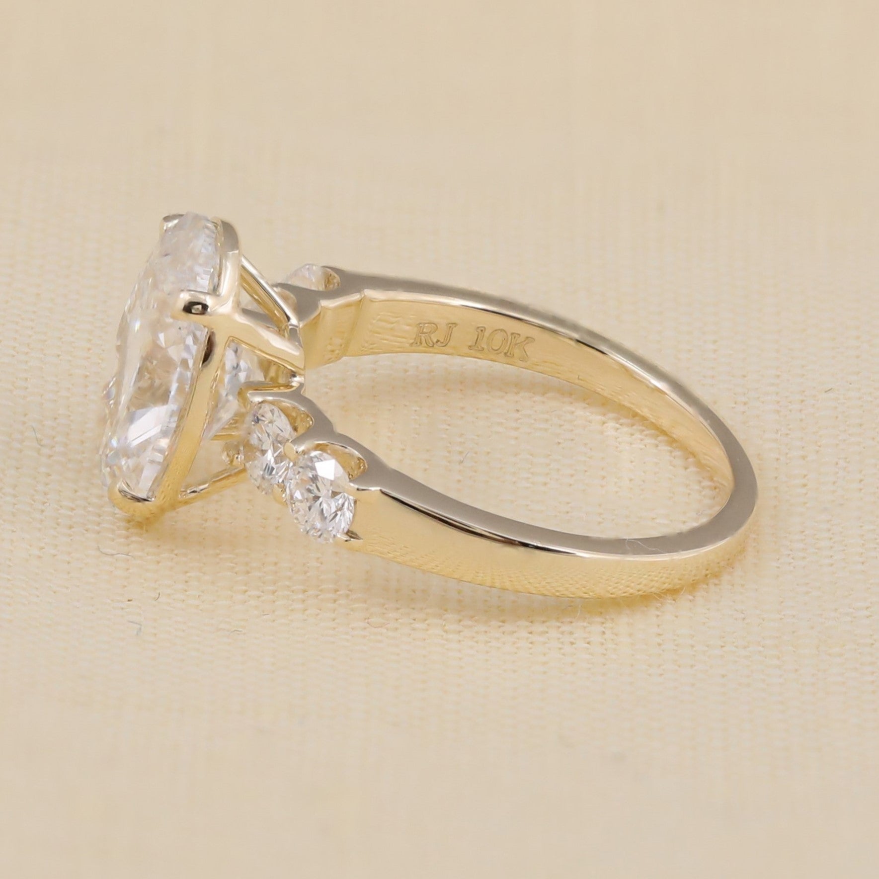 Oval cut center stone ring with sparkling round accents